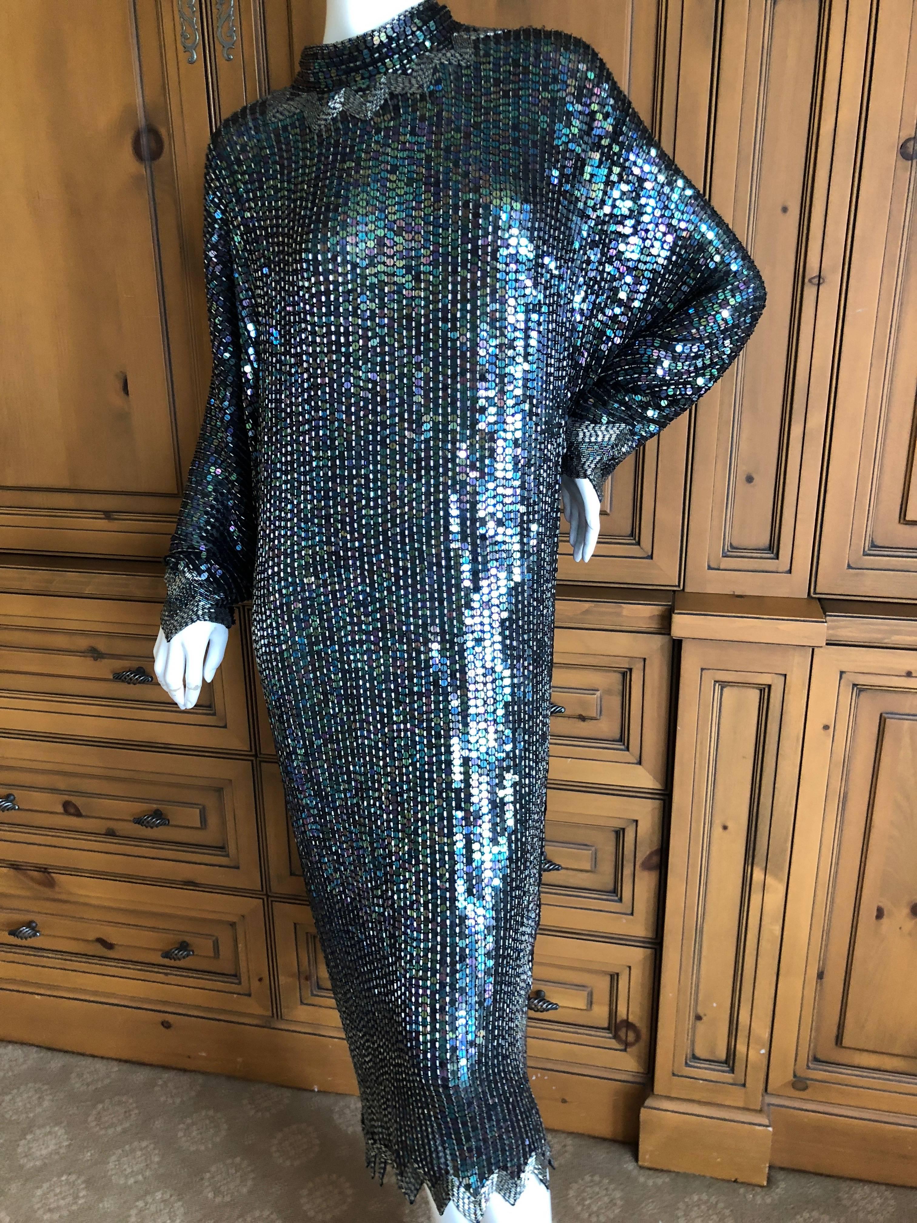 Halston 1970's Iridescent Sequin Bugle Bead Embellished Batwing Disco Dress.
From I Magnin, once on of San Francisco's chicest fabled department stores.
This is so much prettier than the photos show, and needs to be seen in motion, preferably under
