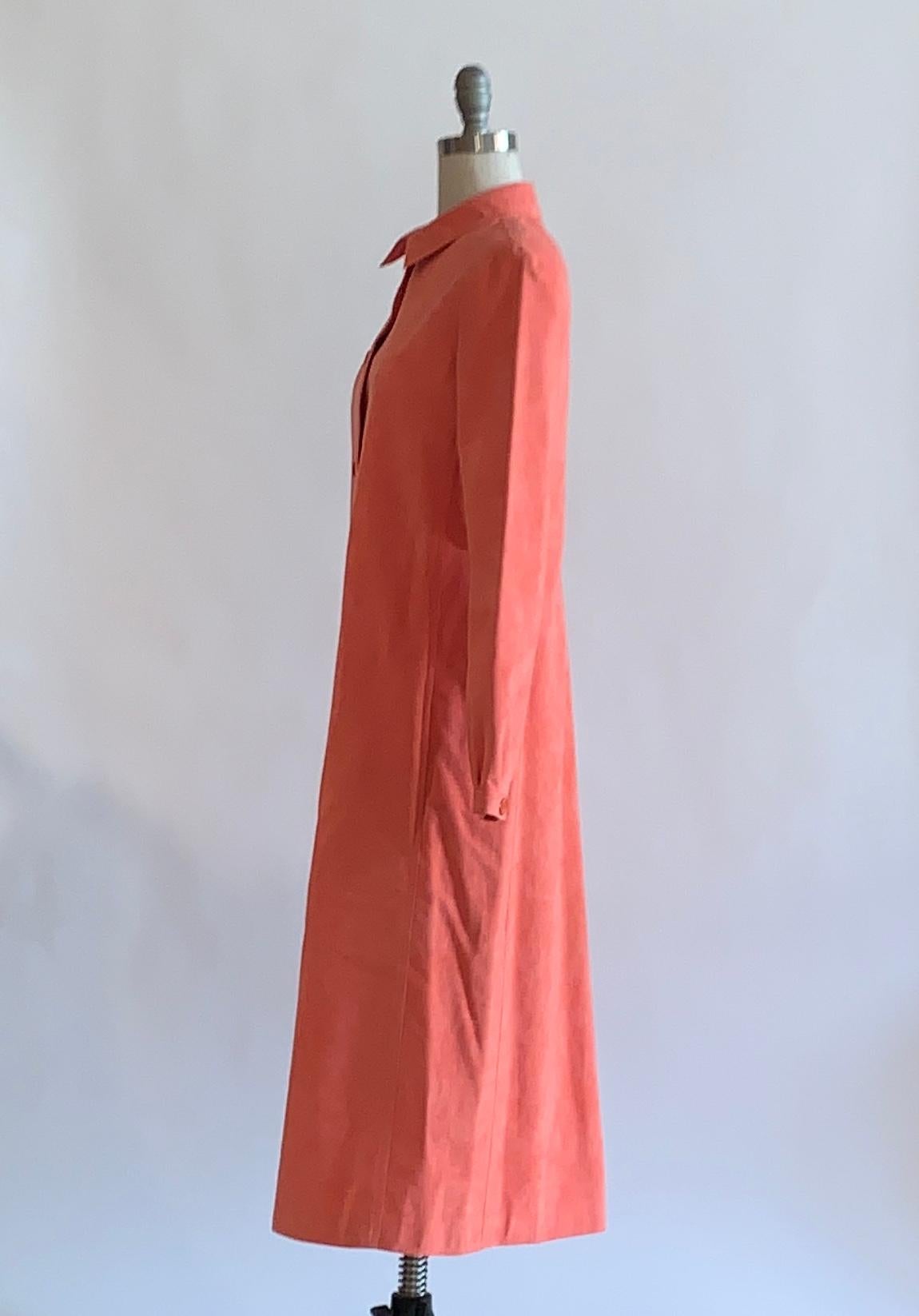 Vintage Halston 1970s collared long sleeve ultrasuede coat in an amazing shade of orange-pink coral. Long sleeve, buttons at front and at cuffs. 

Content: Ultrasuede (soft, very real looking washable vegan leather/ faux suede.)

No size label,