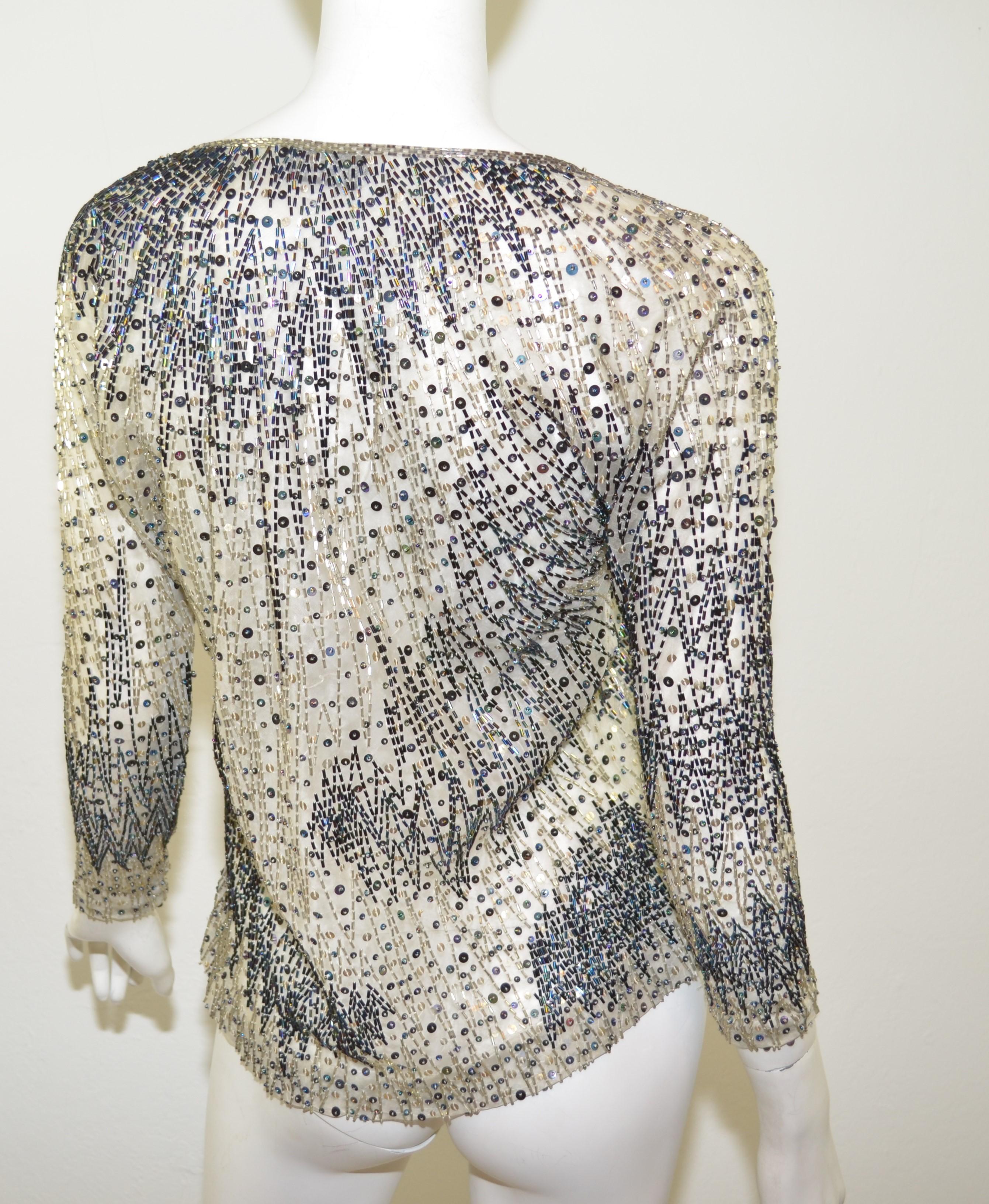 Halston blouse features a full bead and sequin detailing throughout a mesh silk fabric with snap buttons at the cuffs. Blouse is in excellent pre-owned condition with no major flaws to mention.

Bust 34''
Sleeves 21''
Length 24''