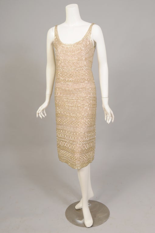 Sparkle plenty, this late 1970's bugle beaded dress just glistens in the light. It really doesn't matter if it is the sun, the moon or the disco this dress just glows. The dress itself is nude colored with a slip made from a double layer of