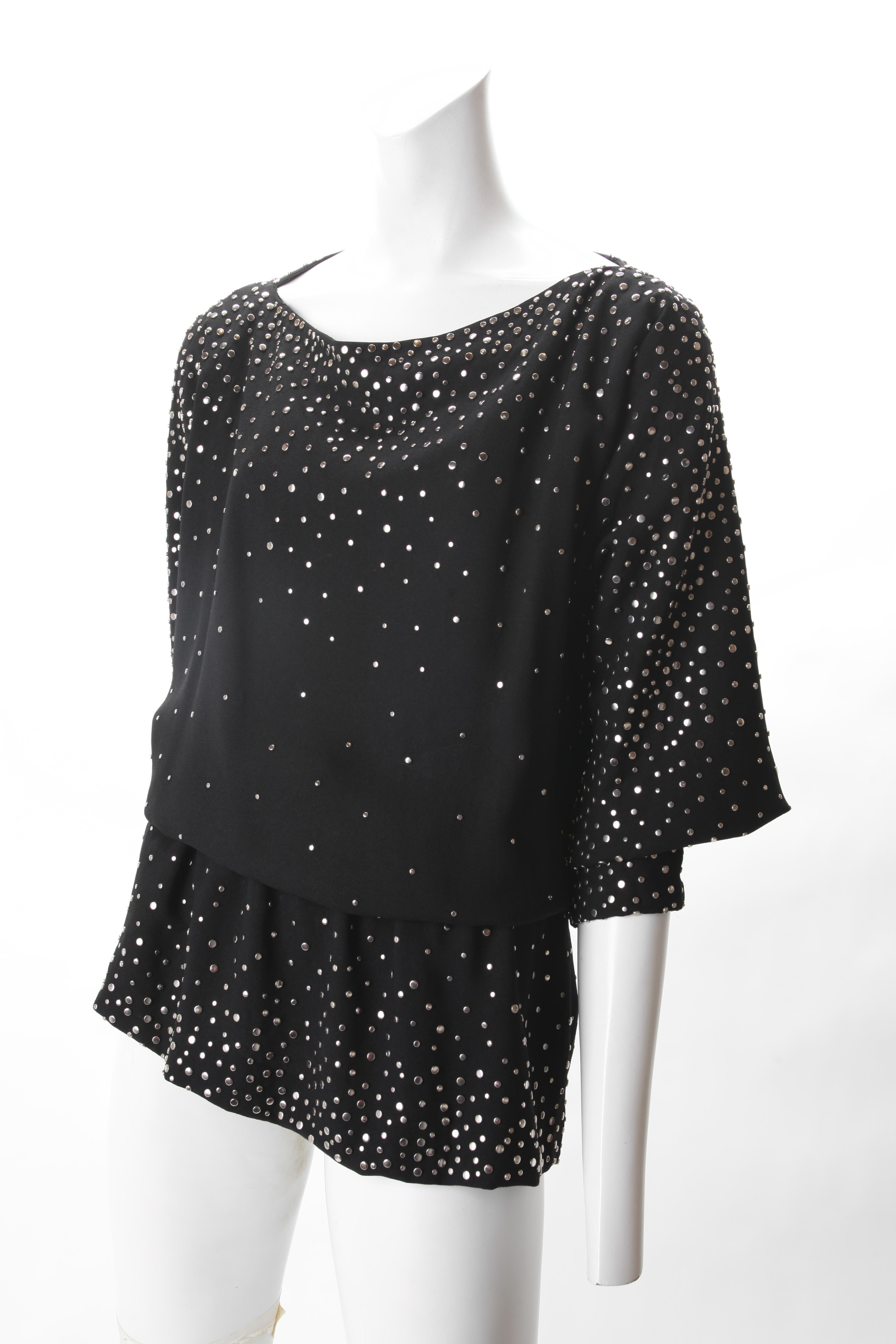 Halston Black Crepe Studded Tunic, c.1970s.
Halston Black Crepe Tunic featuring bateau neckline and elasticated waist. Allover studs creates a Starry night effect.  

Diffusion Line
Fits Us Size : Due to the elasticated waist it is versatile in