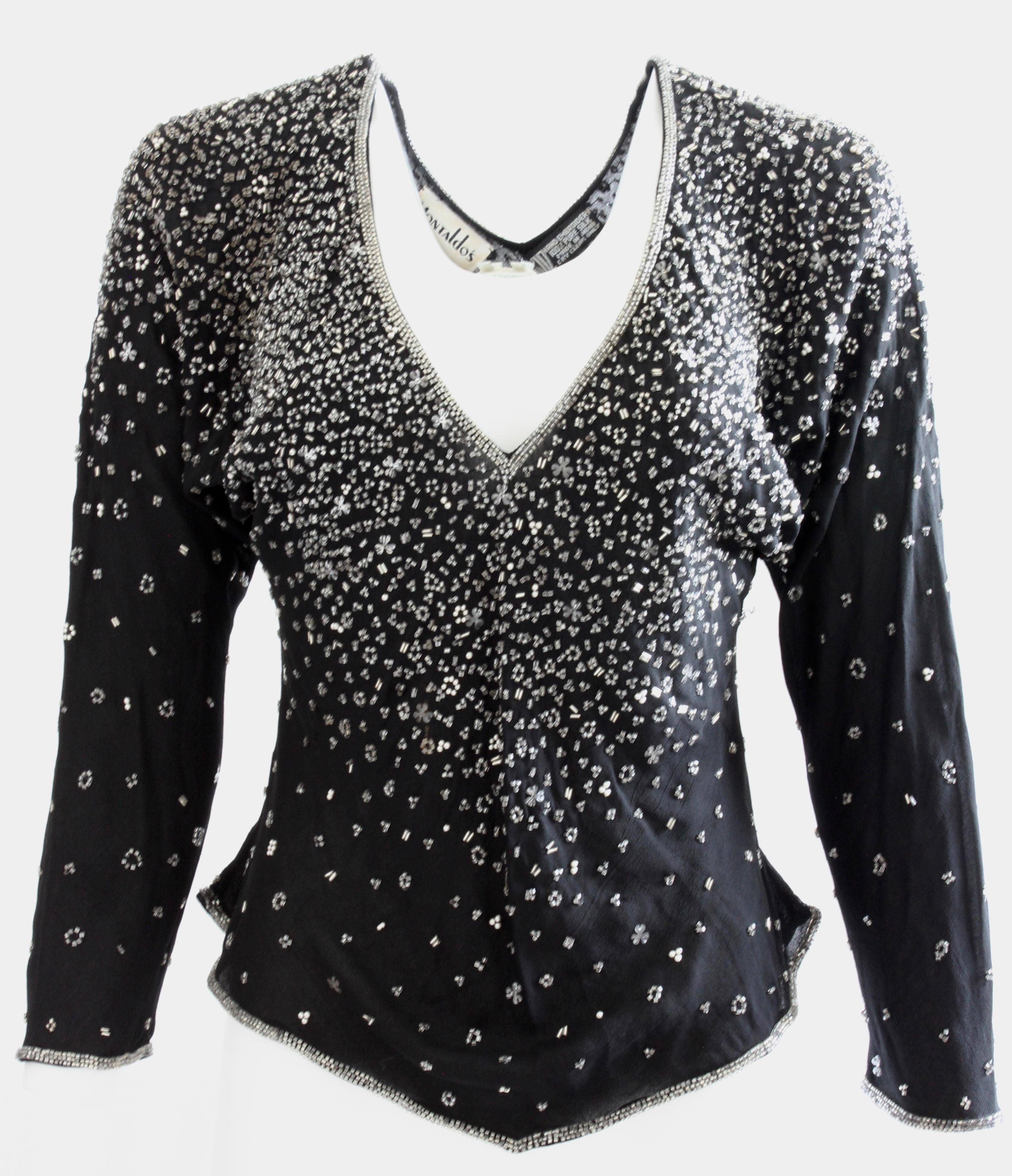 This exquisite black silk blouse was designed by Halston in the early 1970s and sold by Montaldo's, an upscale shop during that period.  Made from black silk and fully-lined, this piece features a confetti pattern of bugle beads, sequins and pear