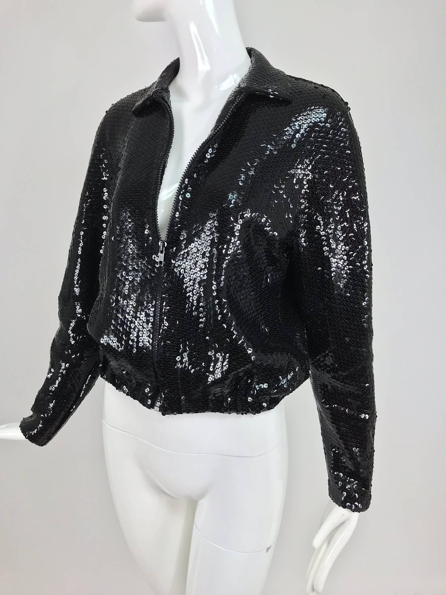 Halston black sequin zip front cropped jacket from the 1970s. Halston's signature simplicity done in a style that was copied by just about everyone in the 70s, but no one did it better than Halston. The cropped baseball jacket here in sleek black