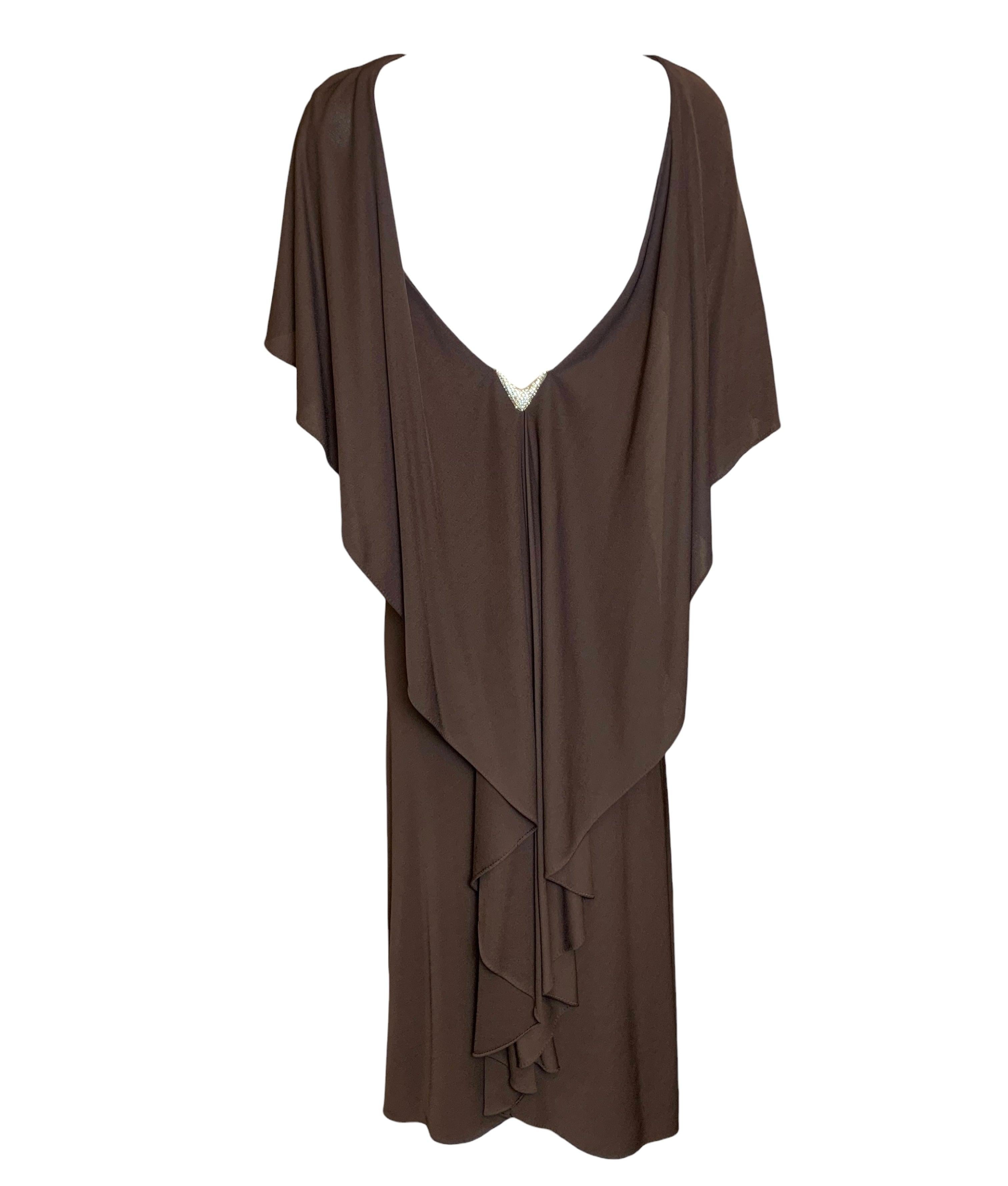 Matte jersey chocolate brown dress by Halston. A beautiful silhouette is created by the draping of the capelet and the trailing jersey down the back moves elegantly with the wearer. Or be daring and wear it the other way around to reveal a super