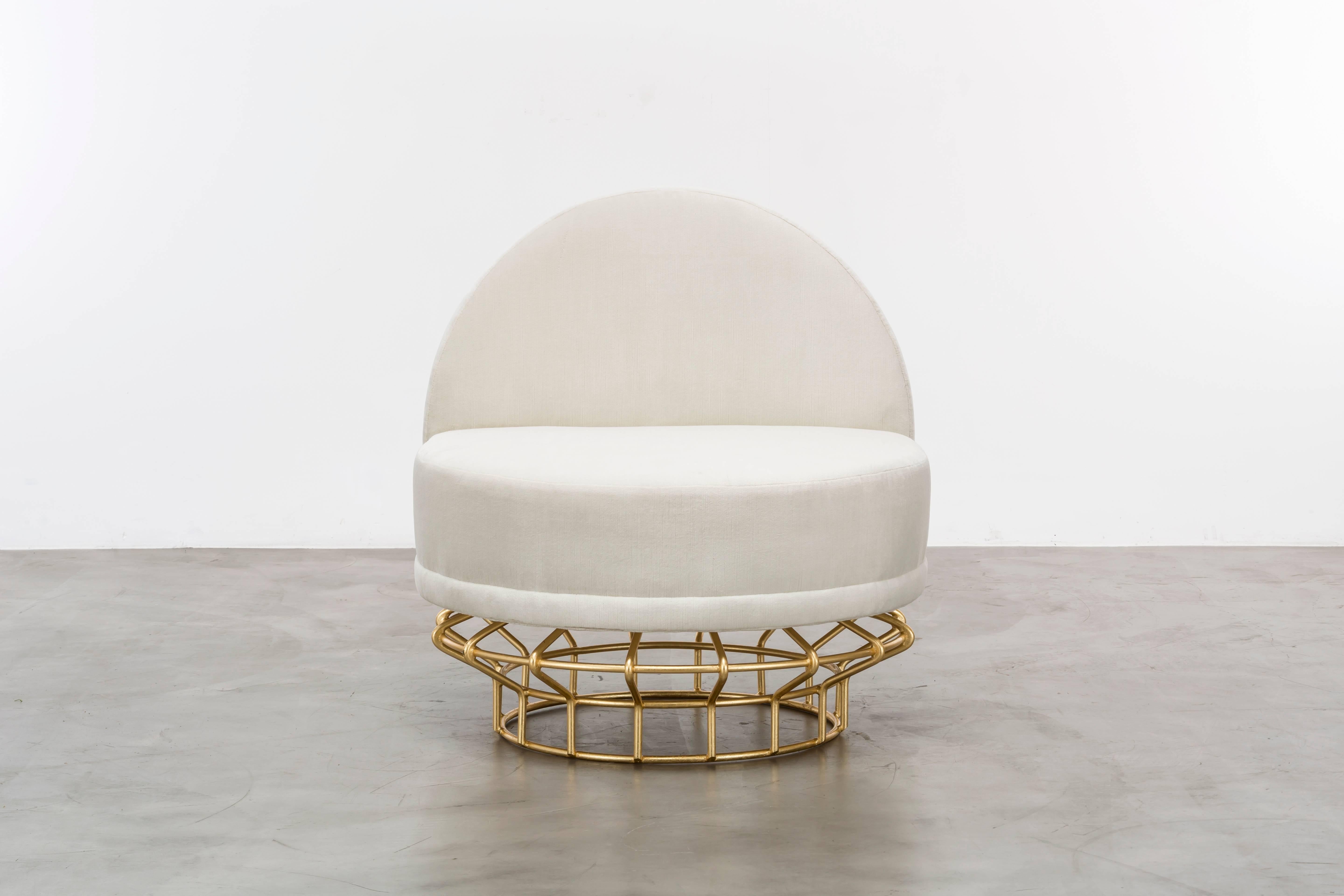 HALSTON CHAIR - Modern Ivory Velvet Chair with a Gold Leaf over Iron Base

The Halston Chair is a beautiful piece of furniture that features a tightly upholstered seat and back, which is elevated by a gold leaf over an iron base. This chair exudes