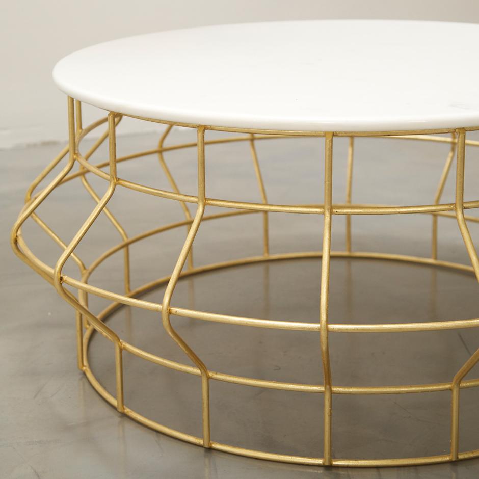 HALSTON COFFEE TABLE - Gold Leaf over Iron and Carrara Marble

The Halston coffee table is a modern and elegant cocktail table that features a gold leaf finish over iron with a beautiful Carrara marble top. It is inspired by jewelry and is designed