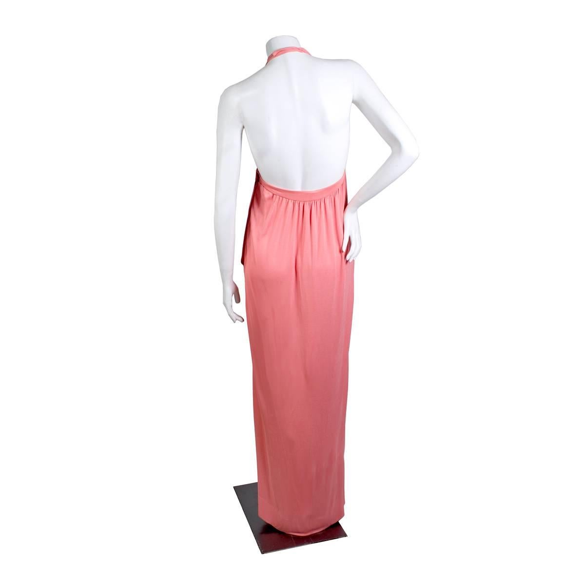 Dress and sweater set by Halston circa 1970s
Double layered light coral pink jersey material
Halter neckline with two hook and eye closures in back of the neck
Includes matching cardigan style sweater with no closures
Condition:  Great vintage