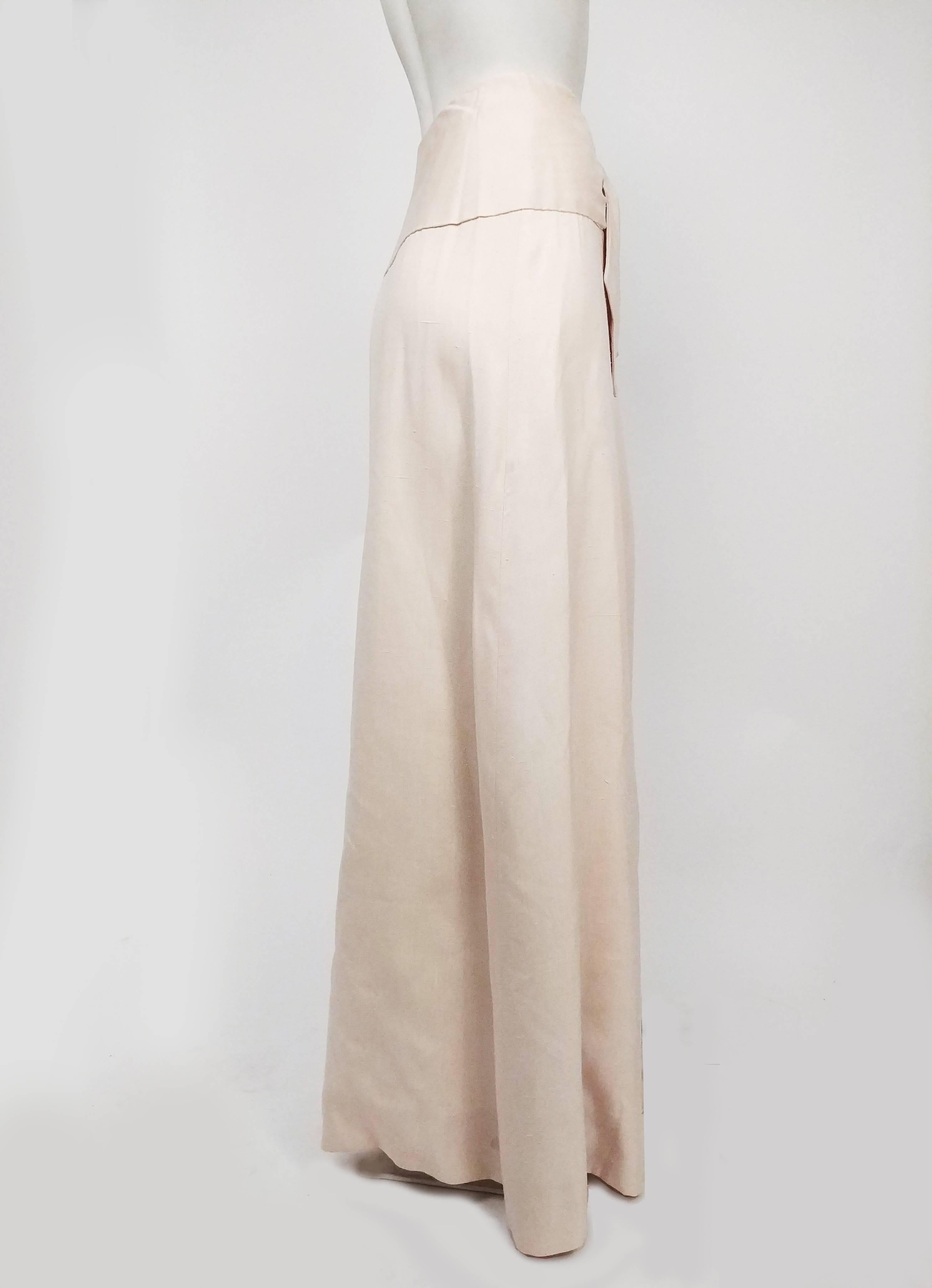 Halston Cream Linen Wraparound Maxi Skirt, 1970s. Cream linen skirt, ties at waist into bow at front, additional snaps at waistband for support. 