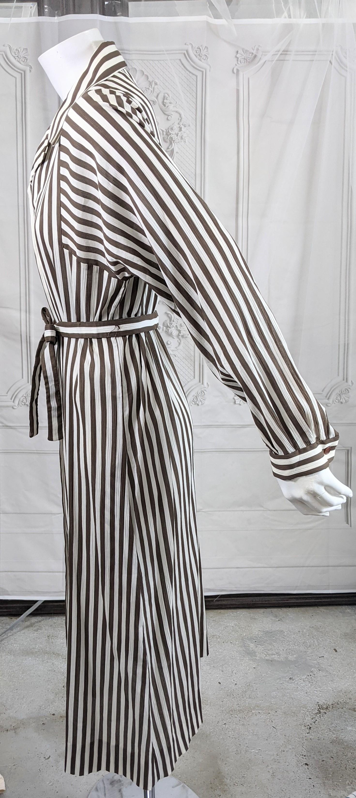 Elegant and timeless Halston Crinkle Chocolate Cotton Striped Day Dress in a shirtwaist style with self belt. Deep dolman sleeves have stripes running lengthwise.
Old stock with additional buttons. Lightweight cotton, with dyed mother of pearl