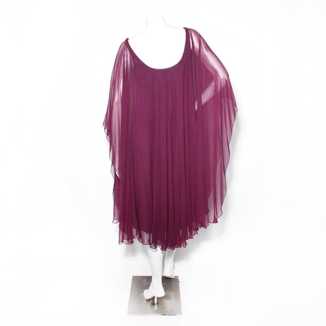 Goddess Dress by Halston 
Circa 1970s
Burgundy
Draped sleeves
Slip-on
Scoop neck dress
Sheer sleeves layers
Lined interior
Condition: Excellent vintage condition (see photos)
Size/Measurements: (approximate, taken flat)
36
