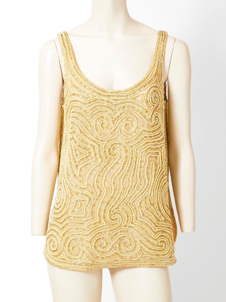 Halston, gold, embroidered and open work, beaded, evening jacket with a matching tank ensemble.
Both pieces are encrusted with pearls and bugle beads. Jacket is collarless with no closures and falls below the hip. Tank is sleeveless with an open