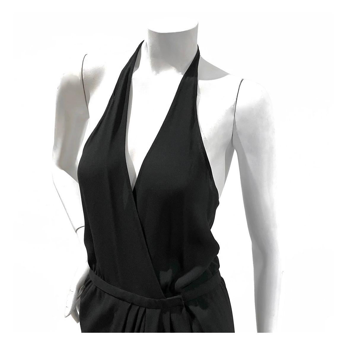 Halter wrap dress by Halston
1970's
Black crepe jersey
Wrapping surplice bodice
Seamless halter 
Double hidden hook closure at waist 
Asymmetrical drape from waist 
Condition: Excellent vintage condition, no visible wear  
Size/Measurements:  

Size