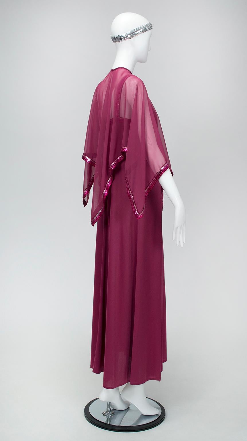 When your Bianca Jagger fix needs attention, turn to this jewel tone maxi dress à la 1970s Halston. The sleek and sinewy gown is balanced by the billowing butterfly capelet, whose edges are trimmed in sequins that catch light like a disco ball. A