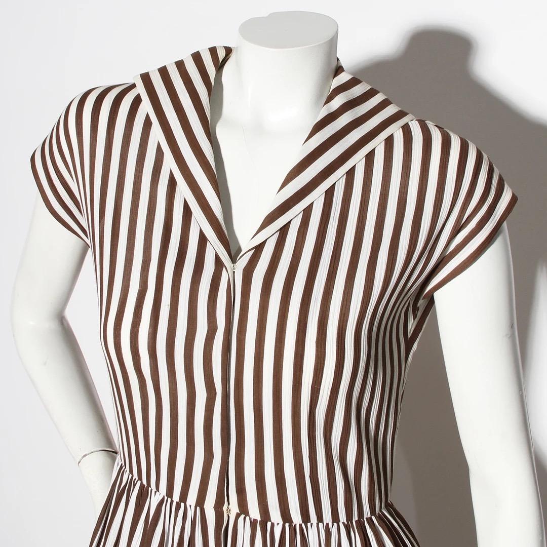 Halston Dress
Vintage 
Circa mid-1970's 
Brown and white
Vertical Striped pattern
V-neckline with flat collar 
Snap-button closure down the center to waist 
Fit and flare style silhouette 
Skirt has slight pleat detailing from ruching at waist 
Good