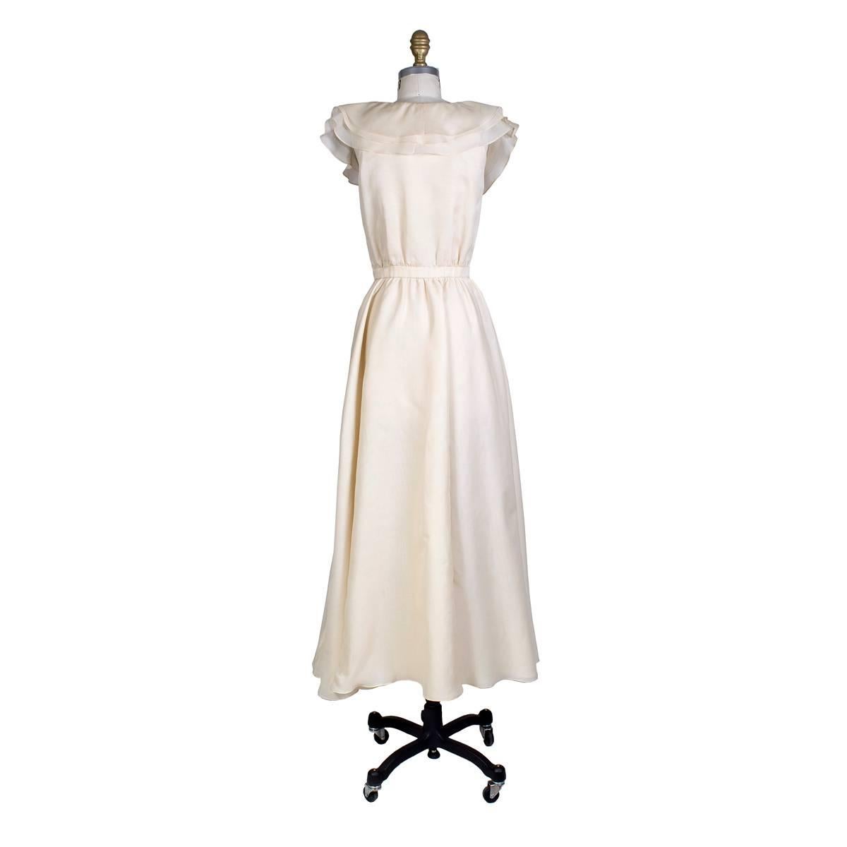 Vintage dress by Halston circa 1970s
Cream colored heavy organza
Wrap style in front with hook closures inside of waist
3 layered large collar and multi layered skirt to create volume
Condition: Excellent vintage condition
Size/Measurements:
32