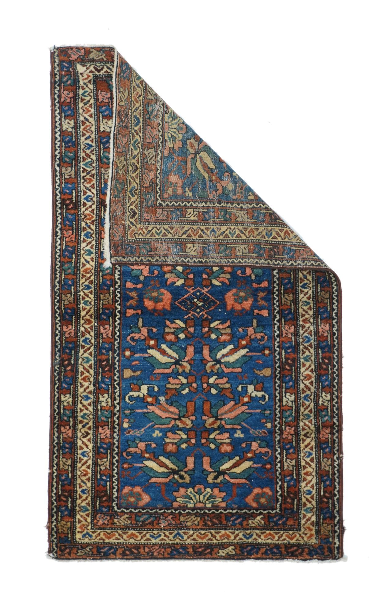 This small west Persian rustic scattershows a middle blue field decorated by floral modules in cream, green and red, facing off around a small central lozenge. Triple narrow borders, with red minors in flip-flop palmette meanders, and a central ecru