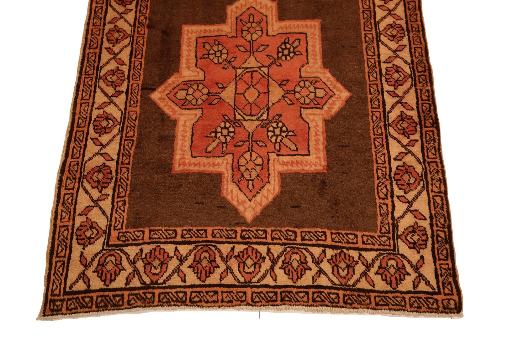 Introducing the Hamedan Runner – a captivating piece that effortlessly blends tradition with contemporary allure. This intricately crafted rug boasts a warm and inviting brown background, setting the stage for a mesmerizing display of salmon-colored