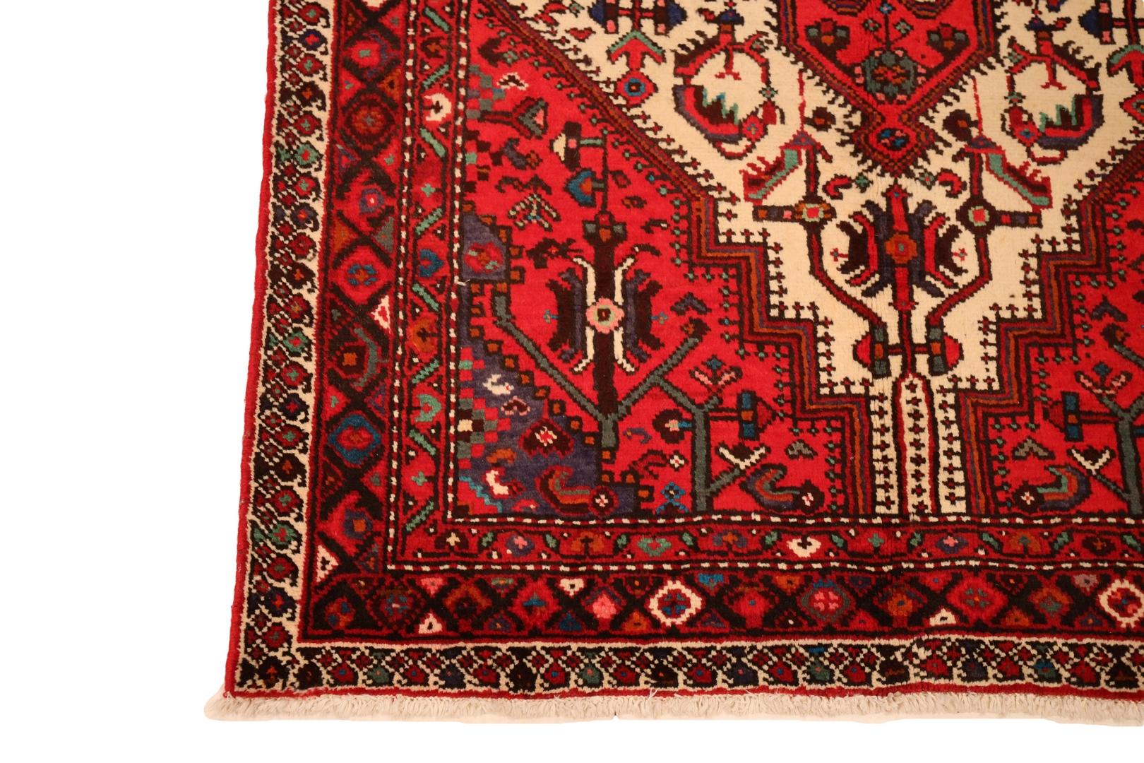 Introducing the enchanting Hamedan rug, a masterpiece of craftsmanship and artistry that exudes timeless elegance. With a captivating red background, this rug takes center stage in any space. At its heart lies a magnificent ivory medallion,