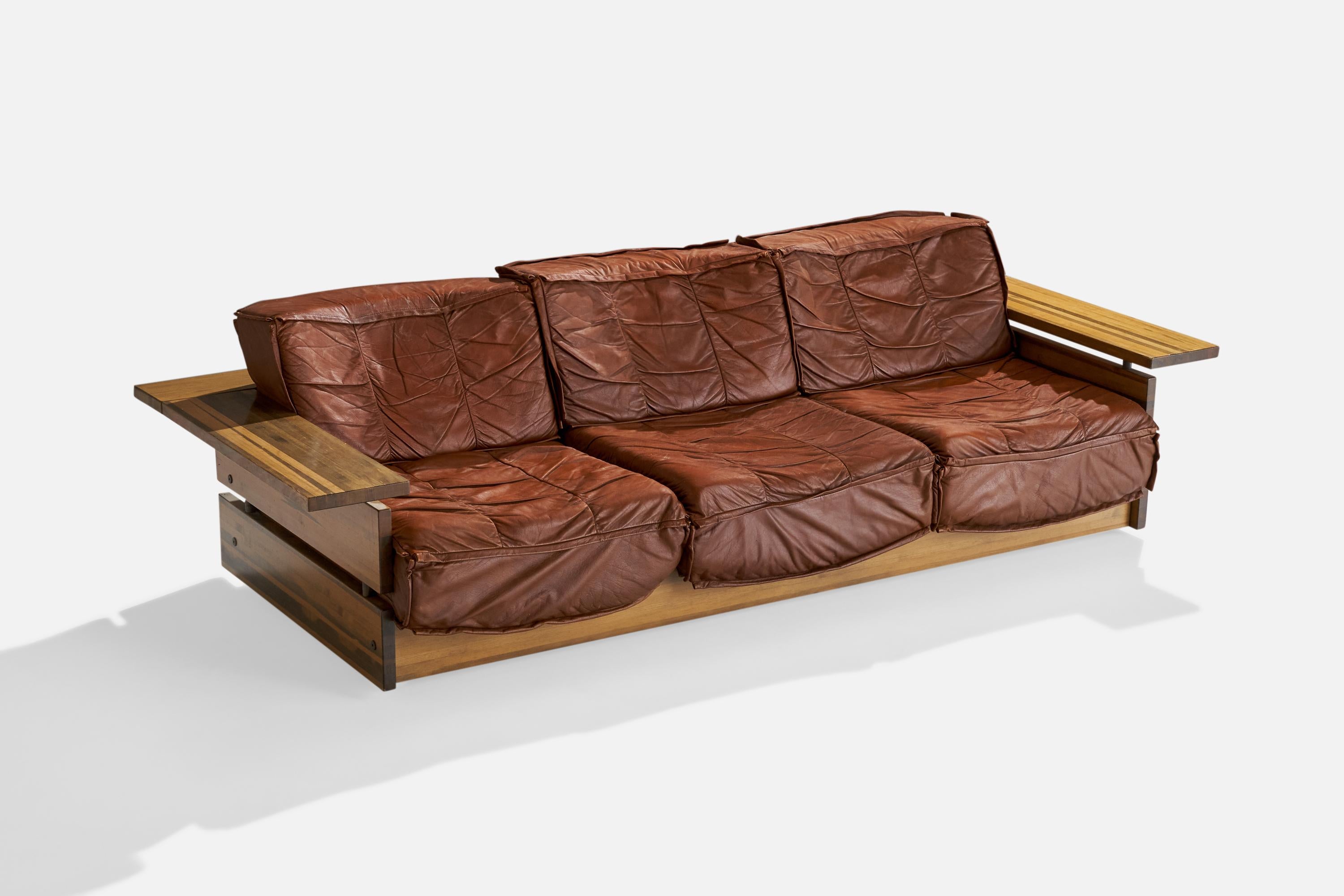 A pine and brown leather sofa designed and produced by Hämeen Kalustaja, Finland, 1970s.

Seat height 14”.