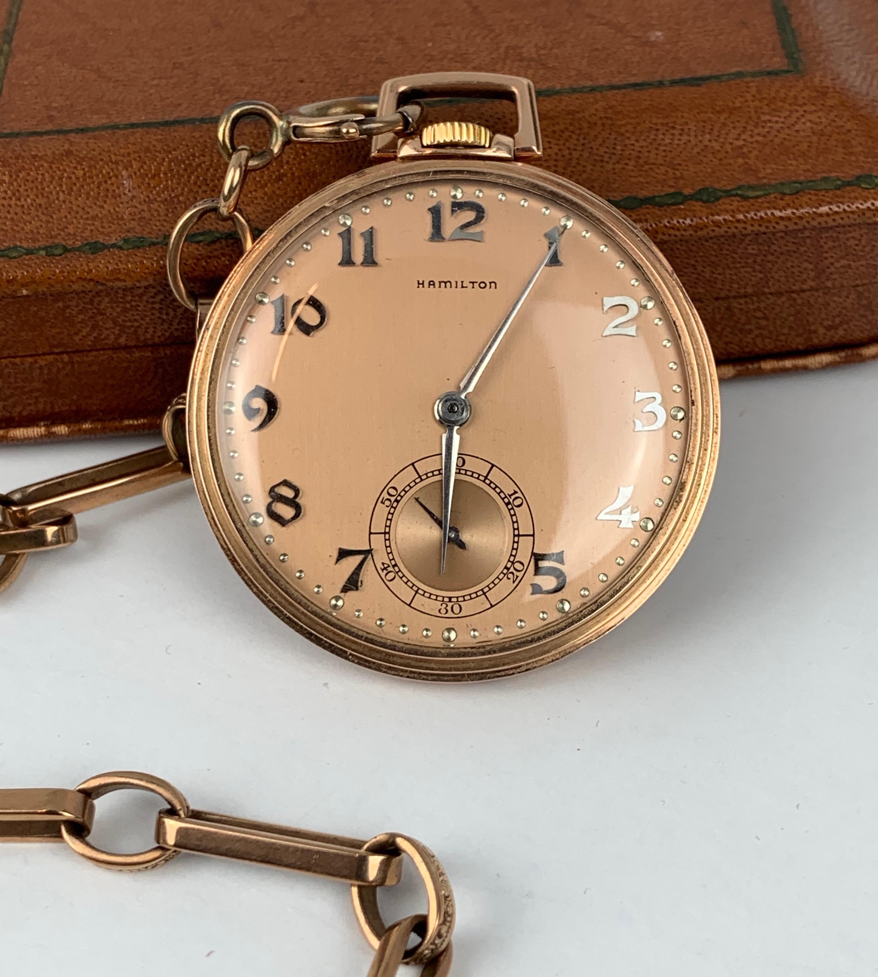Hamilton Watch Compny's 14k rose gold open faced pocket watch and chain with original presentation case..  When you research the movement serial number of #1205496 October 21, 1916 comes up as its date of manufacture.  The open face 1/4