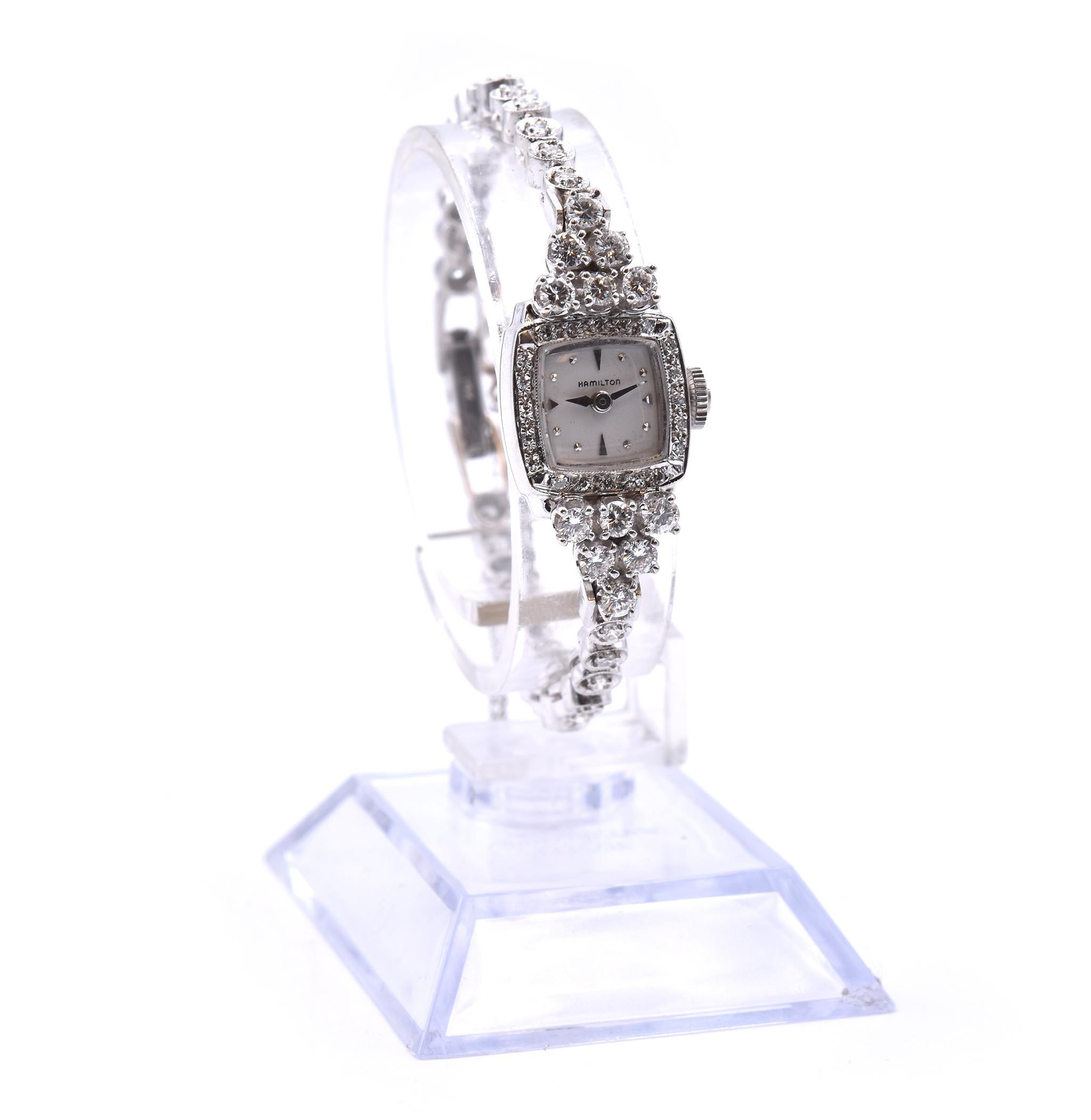 Movement: manual wind
Function: hours, minutes
Case: 14.19mm x 12.85mm case
Dial: silver dial with silver hour markers and hands
Band: 14k white gold diamond set bracelet
Diamond: 58 round brilliant cuts = 1.56cttw
Color: G-H
Clarity: VS
Weight: