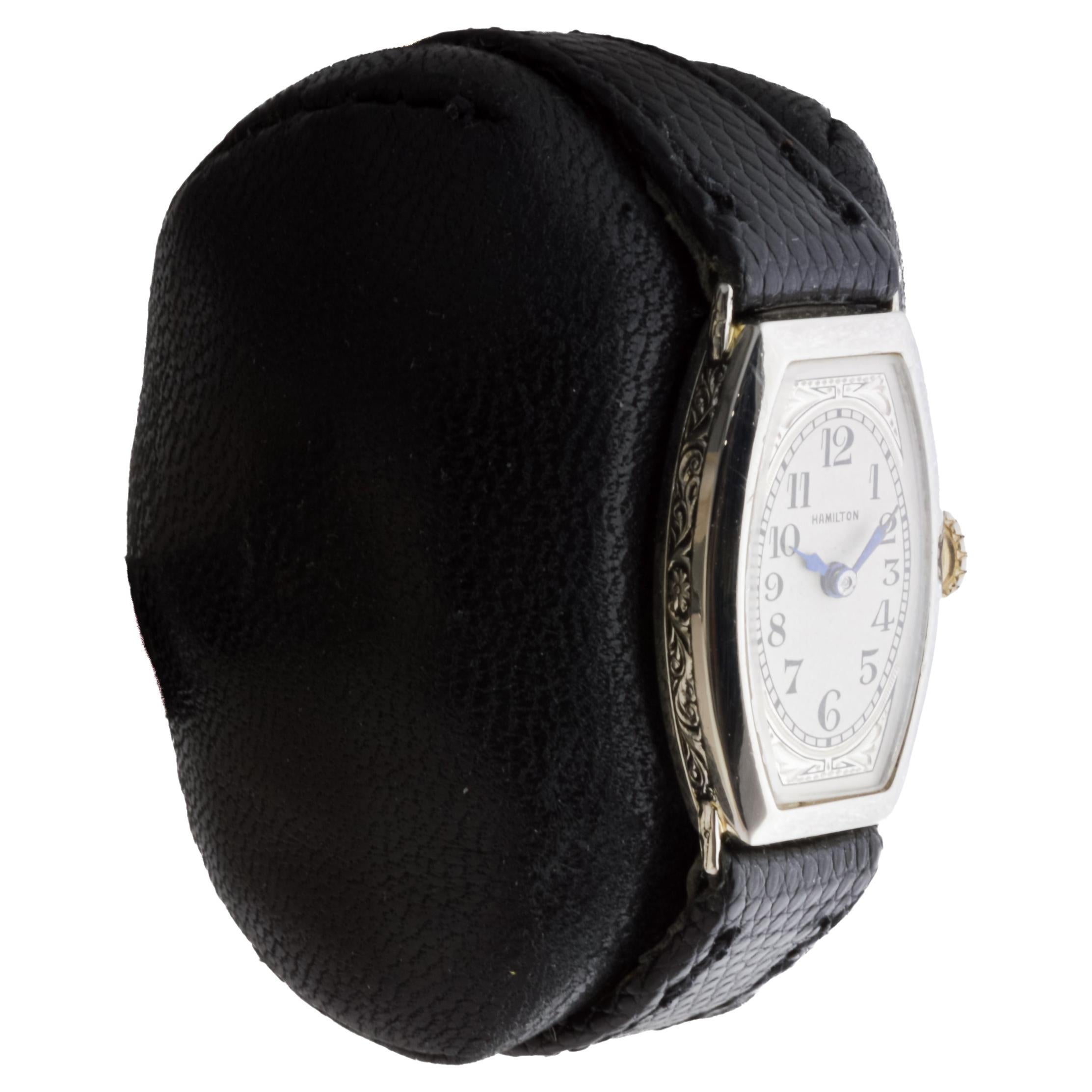 FACTORY / HOUSE: Hamilton Watch Company
STYLE / REFERENCE: Art Deco / Tonneau Shape
METAL / MATERIAL: 14Kt Solid Gold
CIRCA / YEAR: 1930's
DIMENSIONS / SIZE: Length 31mm X Width 16mm
MOVEMENT / CALIBER: Manual Winding / 17 Jewels / Caliber 989 
DIAL