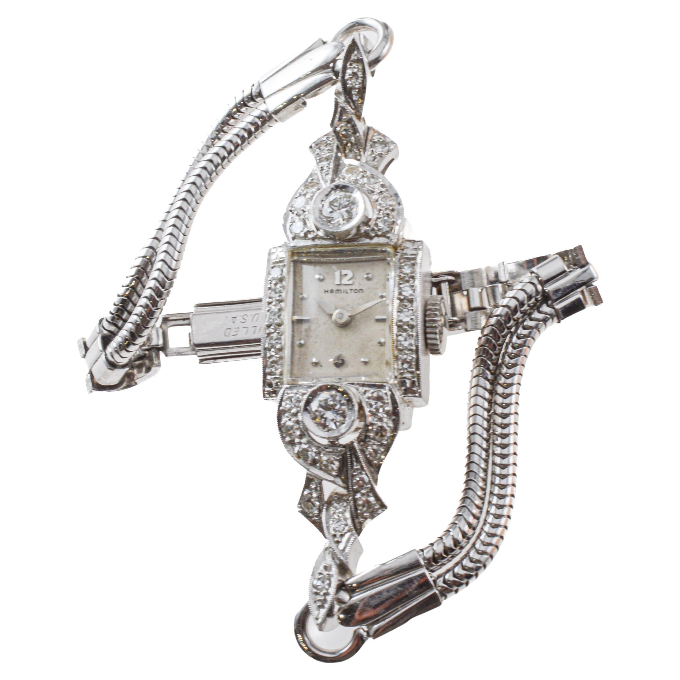 FACTORY / HOUSE: Hamilton Watch Company
STYLE / REFERENCE: Art Deco
METAL / MATERIAL: 14Kt. Solid White Gold
CIRCA / YEAR: 1950's
DIMENSIONS / SIZE: Length 36mm X Width 14
MOVEMENT / CALIBER: Manual Winding / 17 Jewels / Caliber 750
DIAL / HANDS: