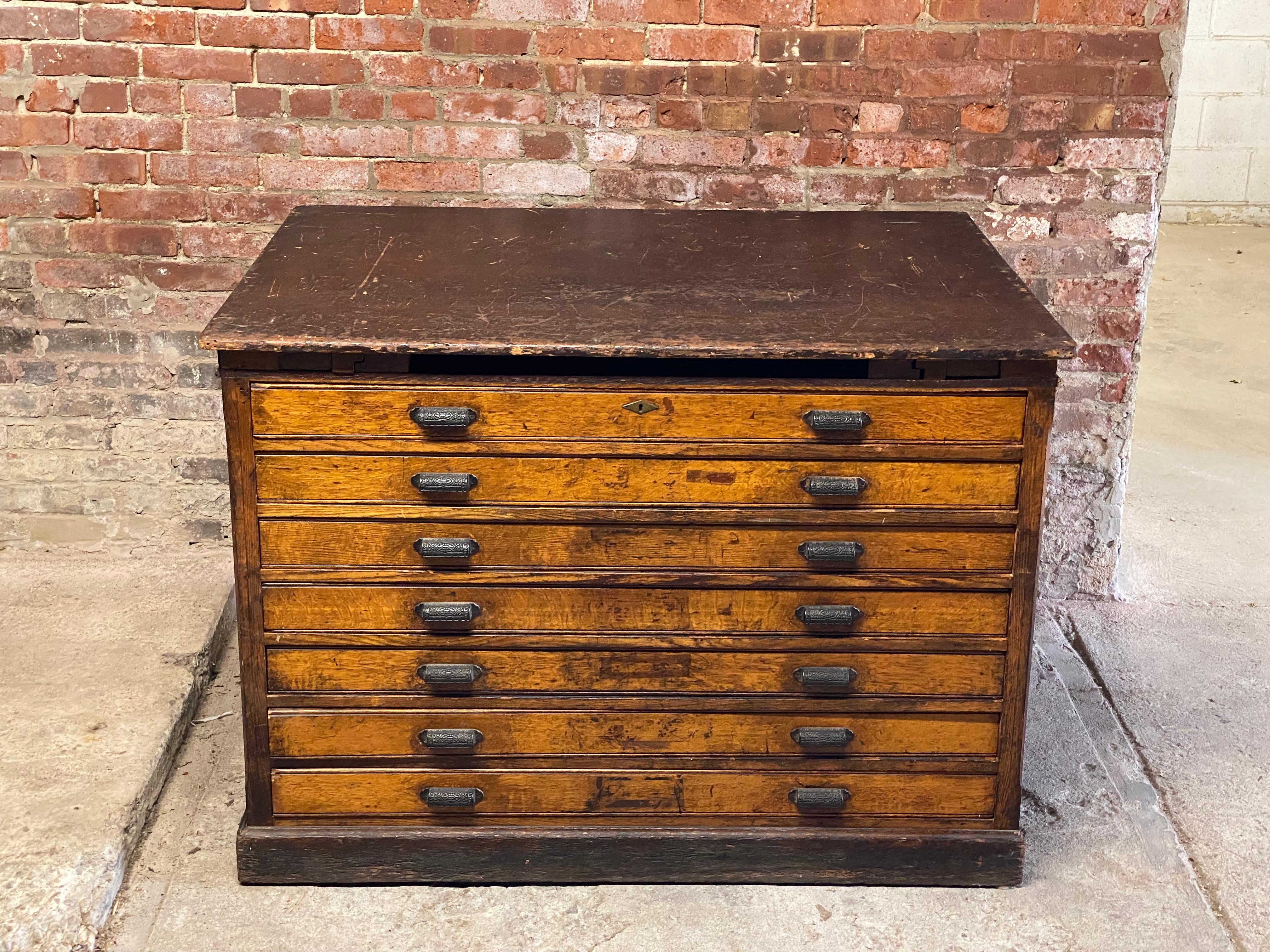 Massive Hamilton artist's/printer flat file. Circa 1890-1910. These are wonderful for unmounted or loose artwork, prints, photos, etc. Seven drawers. All original hardware. Good overall condition with wear to the finish, scratches, bumps, bruising,