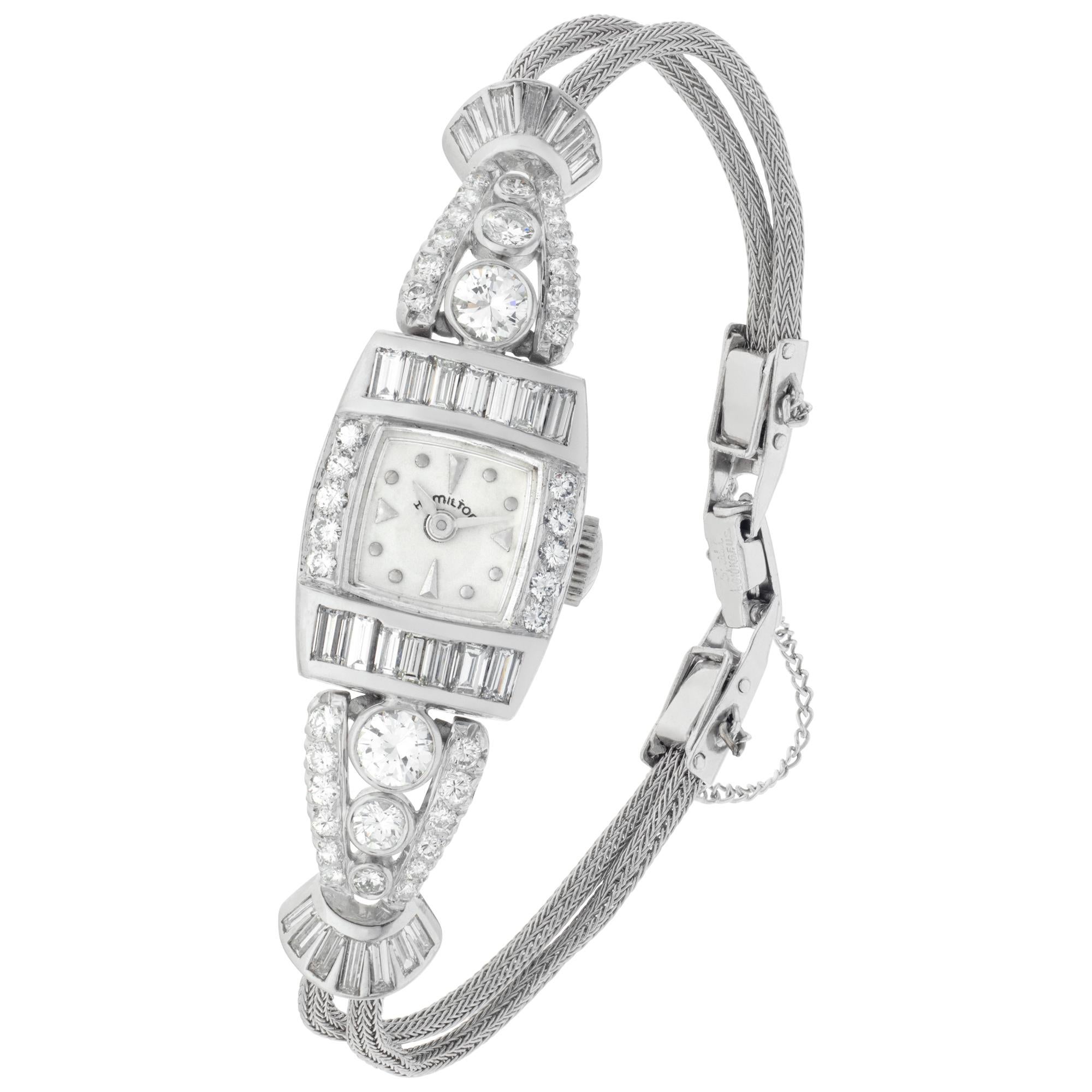 Hamilton diamond Cocktail watch in platinum with approximately 3 carats in G-H color, VS clarity in round and baguette diamonds on gold fill chain bracelet. 22 jewel manual wind movement. 14.5 mm case size. Circa 1950s. Fine Pre-owned Hamilton