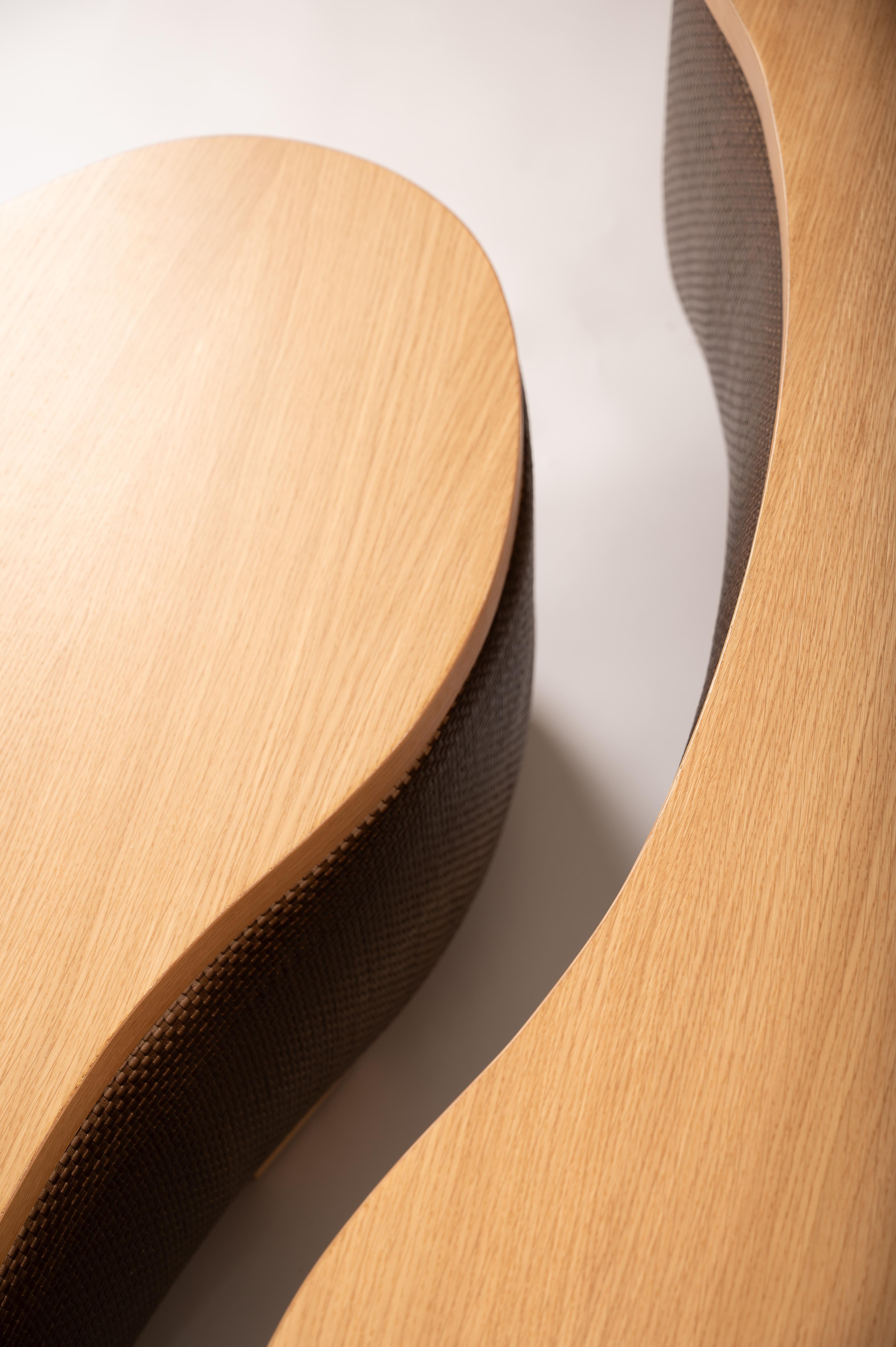 The Hamilton design features two versatile coffee tables that seamlessly combine style and functionality. The lower piece serves as a fully upholstered ottoman, providing an elegant multi-purpose option for any room. With its innovative yin-yang