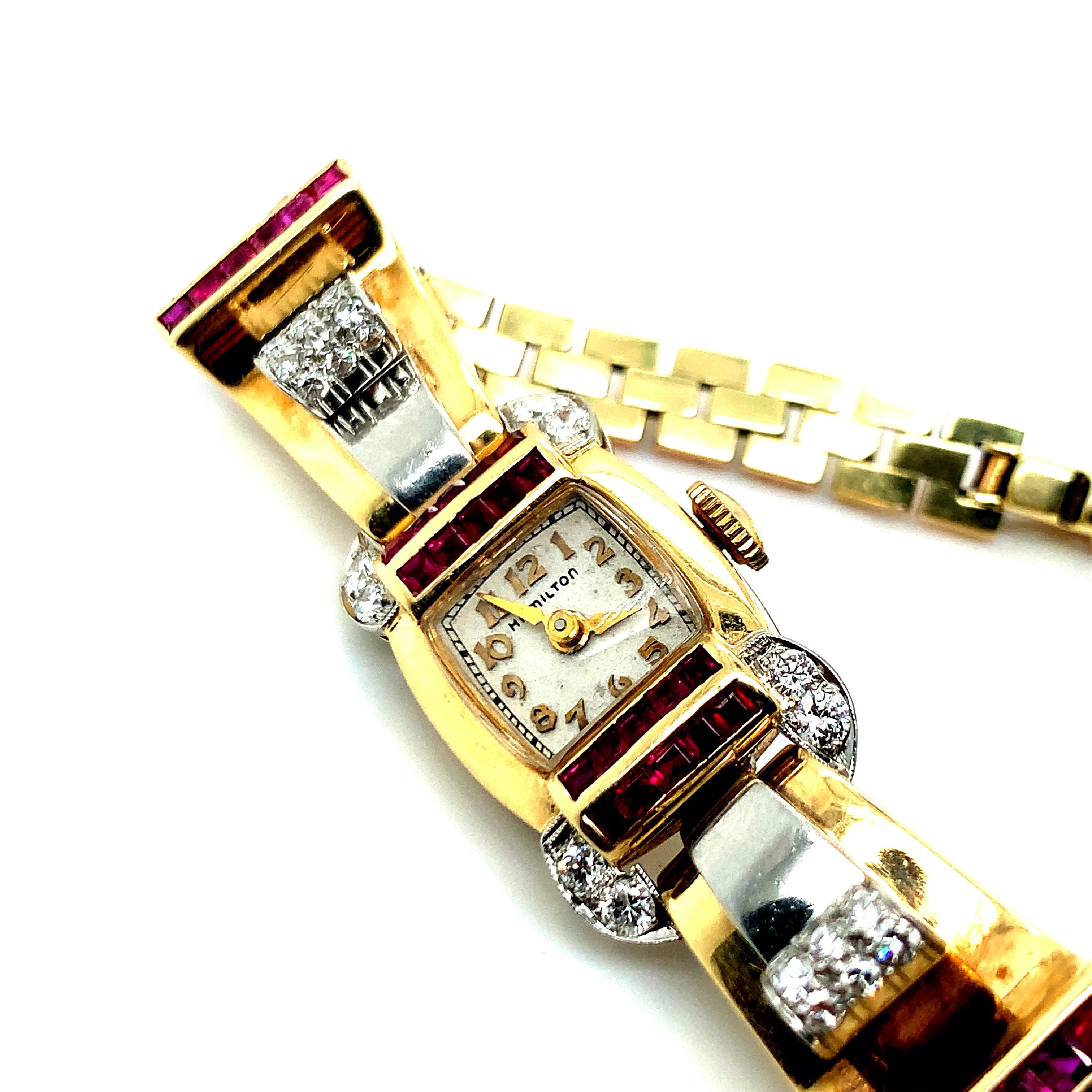A 14 karat yellow, rose, and white gold Hamilton watch with square white dial signed Hamilton, with 17 jewel stem wind and set movement within a 14 karat yellow, rose, and white gold case and bracelet set with thirty-two calibre-cut synthetic rubies