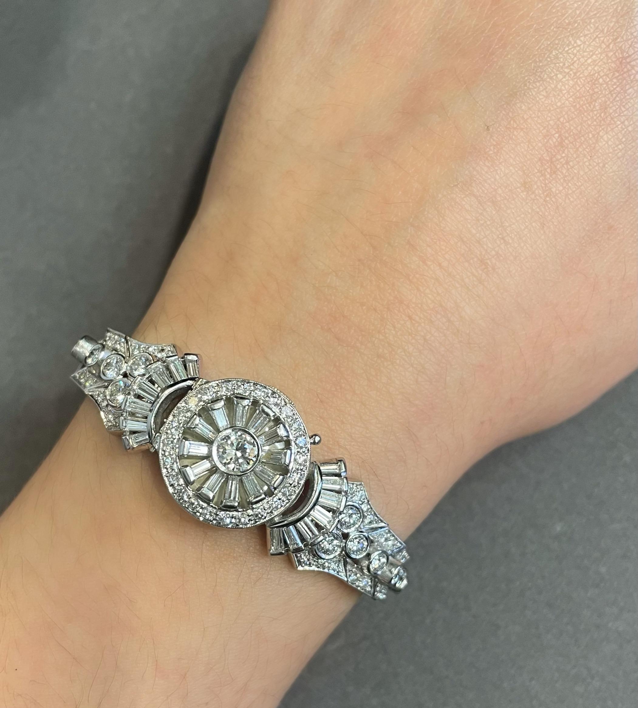 Hamilton Diamond Hidden Watch 

A Hamilton watch adorned with round and baguette-cut diamonds. 

Approximate Diamond Weight: 6.52 carats
Approximate Length: 6 inches
Metal Type: Platinum 
