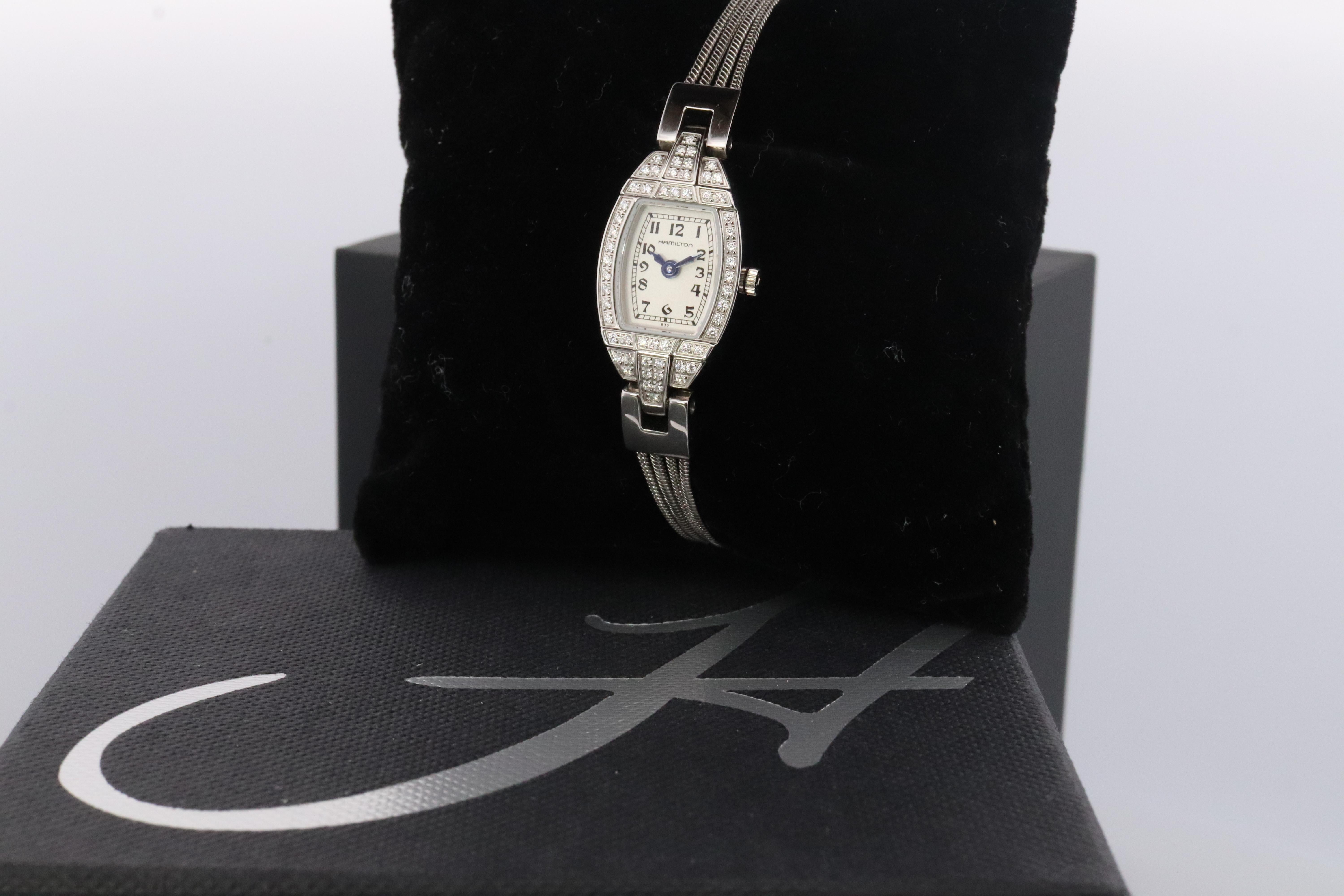 Stunning watch piece. Hamilton Classic quartz wristwatch.

280.002

Stainless Steel with Diamonds

Condition: Watch winds up and ticks. Needs daily winding.

Details:
22mm by 5mm case
Extra links included adjustable up to 7in