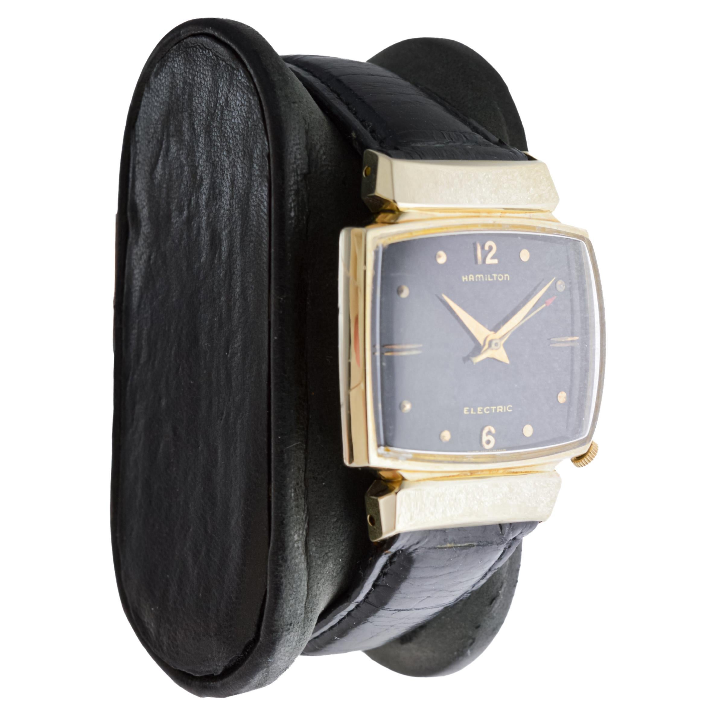  FACTORY / HOUSE: Hamilton Watch Company
STYLE / REFERENCE: Mid Century Design 
METAL / MATERIAL: Yellow Gold Filled
CIRCA / YEAR: Late 1950's
DIMENSIONS / SIZE: Length 27mm X Width 29mm
MOVEMENT / CALIBER: Battery Powered / 12 Jewels Caliber 500