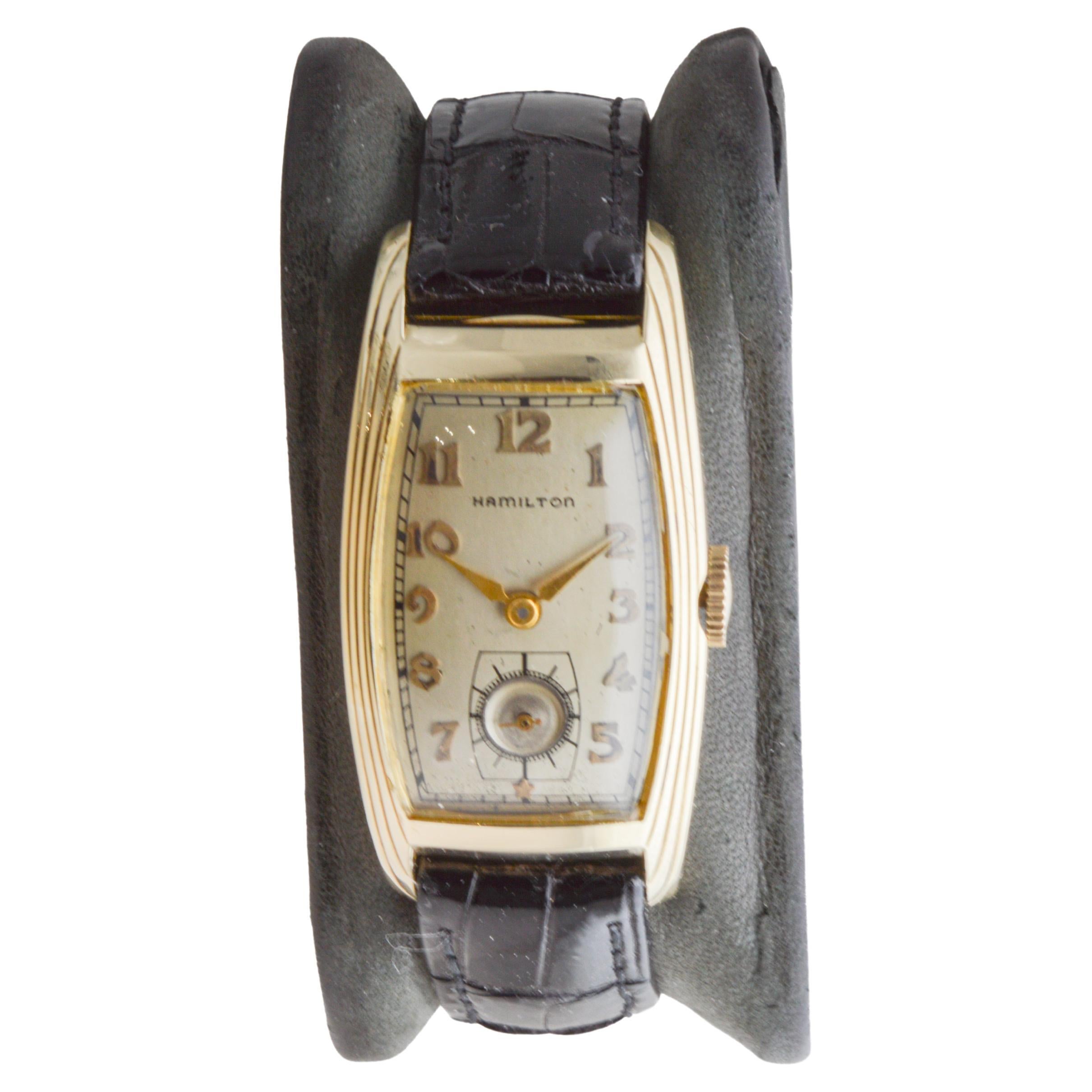 FACTORY / HOUSE: Hamilton Watch Company
STYLE / REFERENCE: Curvex 
METAL / MATERIAL: Yellow Gold Filled
CIRCA / YEAR: 1930's
DIMENSIONS / SIZE: Length 22mm X Width 44mm
MOVEMENT / CALIBER: Manual Winding / 17 Jewels / Caliber: 980
DIAL / HANDS:
