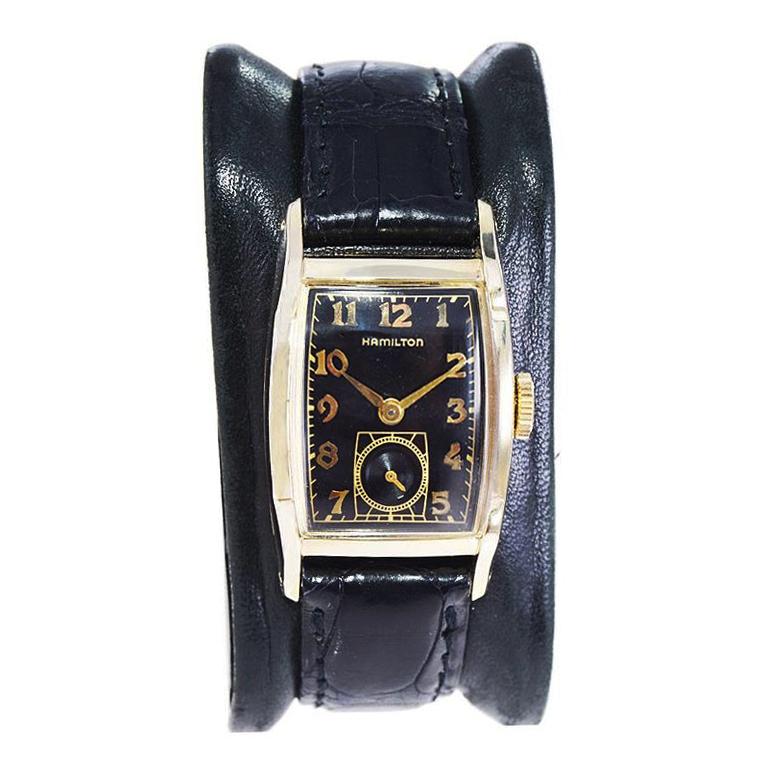 FACTORY / HOUSE: Hamilton Watch Company
STYLE / REFERENCE: Medford Model
METAL / MATERIAL: Yellow Gold Filled 
CIRCA / YEAR: 1950's
DIMENSIONS / SIZE: Length 23mm x Width 38mm
MOVEMENT / CALIBER: Manual Winding / 19 Jewels / Caliber 754
DIAL /