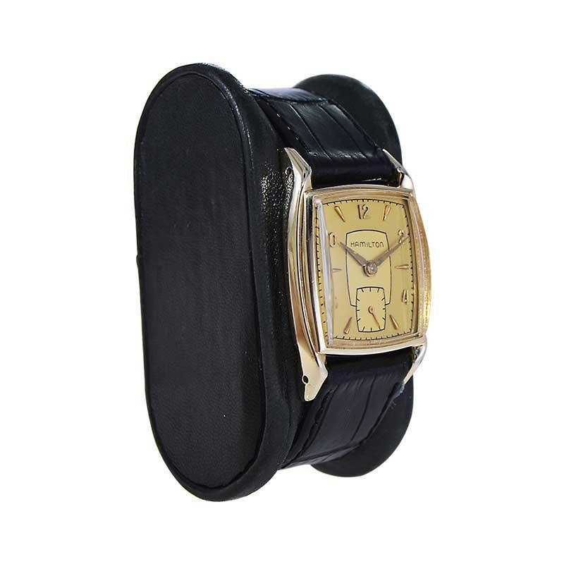 FACTORY / HOUSE: Hamilton Watch Company
STYLE / REFERENCE: Tonneau 
METAL / MATERIAL: Yellow Gold Filled
CIRCA / YEAR: 1950's
DIMENSIONS / SIZE: Length 35mm X Width 26mm
MOVEMENT / CALIBER: Manual Winding / 17 Jewels / Caliber 747
DIAL / HANDS: