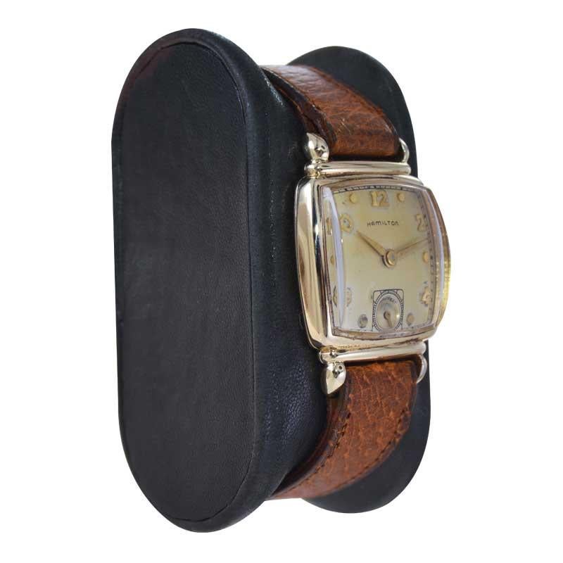 FACTORY / HOUSE: Hamilton Watch Company
STYLE / REFERENCE: Cushion Shaped
METAL / MATERIAL: Yellow Gold Filled 
CIRCA / YEAR: 1940's
DIMENSIONS / SIZE: Length 35mm x Width 24mm
MOVEMENT / CALIBER: Manual Winding / 19 Jewels / Caliber 982
DIAL /