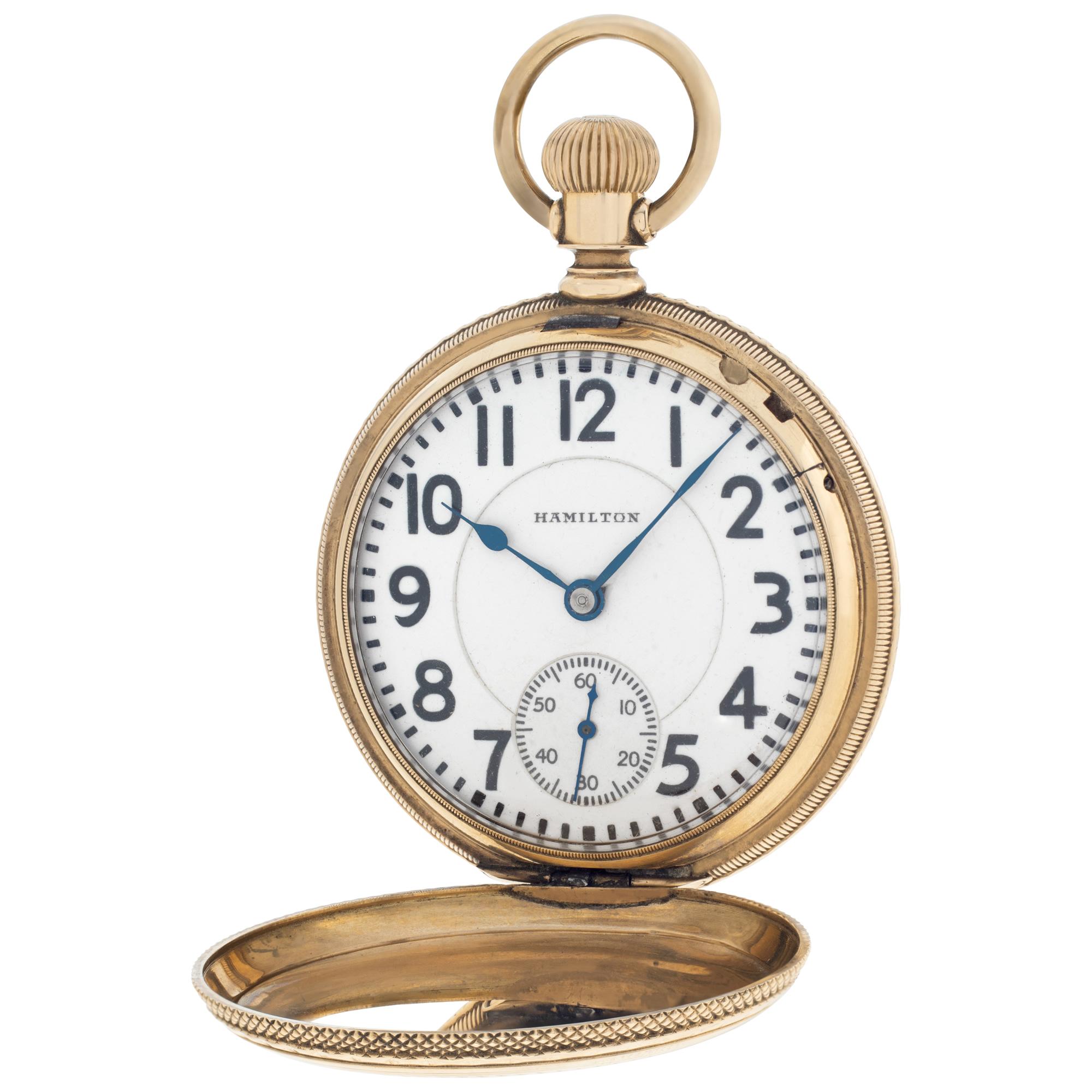 Hamilton Hunter Case pocket watch in 14k yellow gold. Triple sunk white dial with bold Arabic numerals and sub-seconds. 16 size case with 51 mm diameter. Presentation engraving dated 1886. Double roller 21 jewel manual wind movement. Lever set. Ref