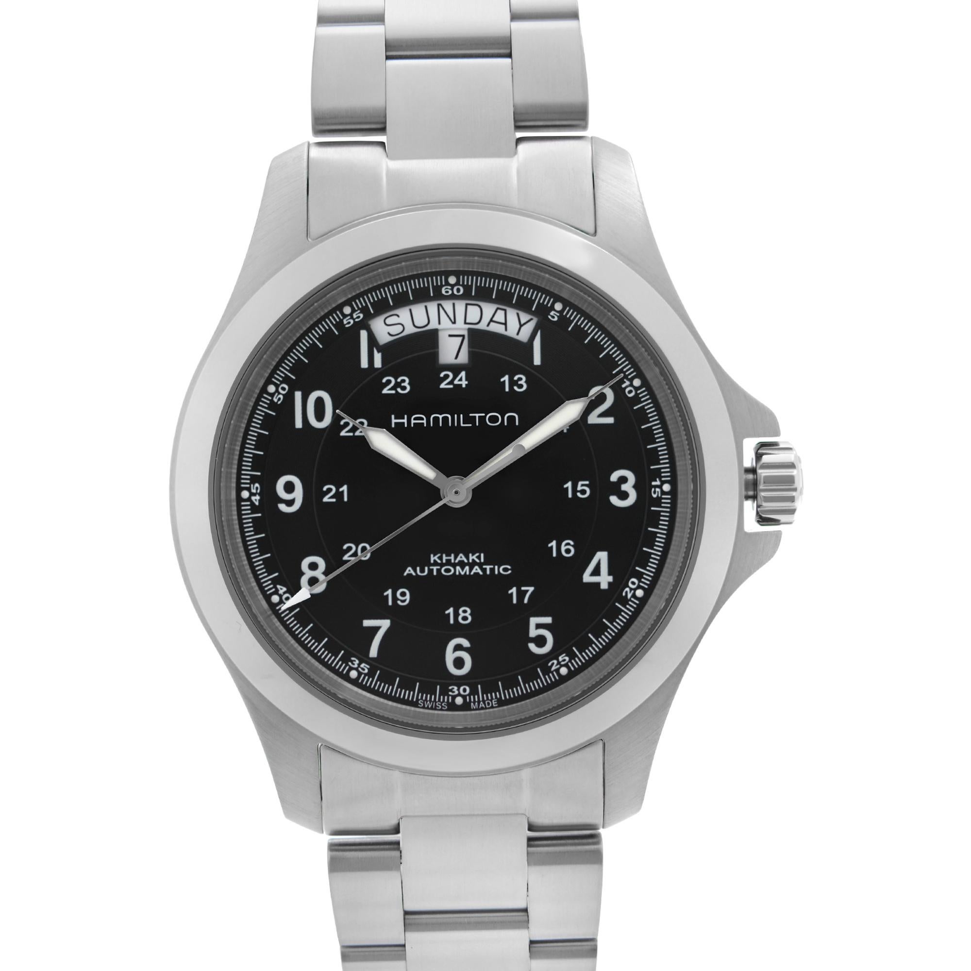 Unworn Hamilton Khaki Field King Men's Watch H64455133. This Beautiful Timepiece Features: Brushed Stainless Steel Case and Bracelet. Fixed Stainless Steel Bezel. Black Dial with Silver-Tone Luminous Hands And Arabic Numeral Hour Markers. 24 Hour
