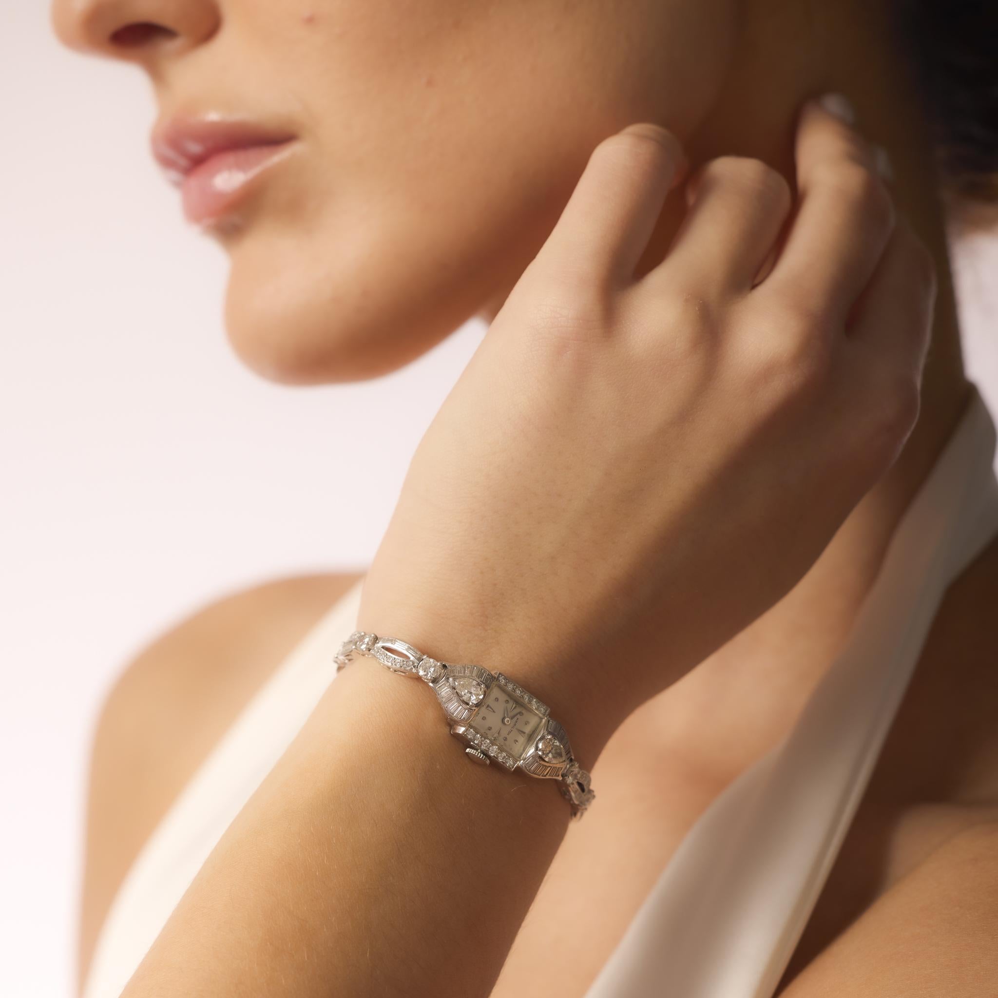 This platinum Hamilton watch from the 1950s showcases 5.20 carats of diamonds, including pear, round, baguette, and single cuts, with manual movement and refined Mid Century design.