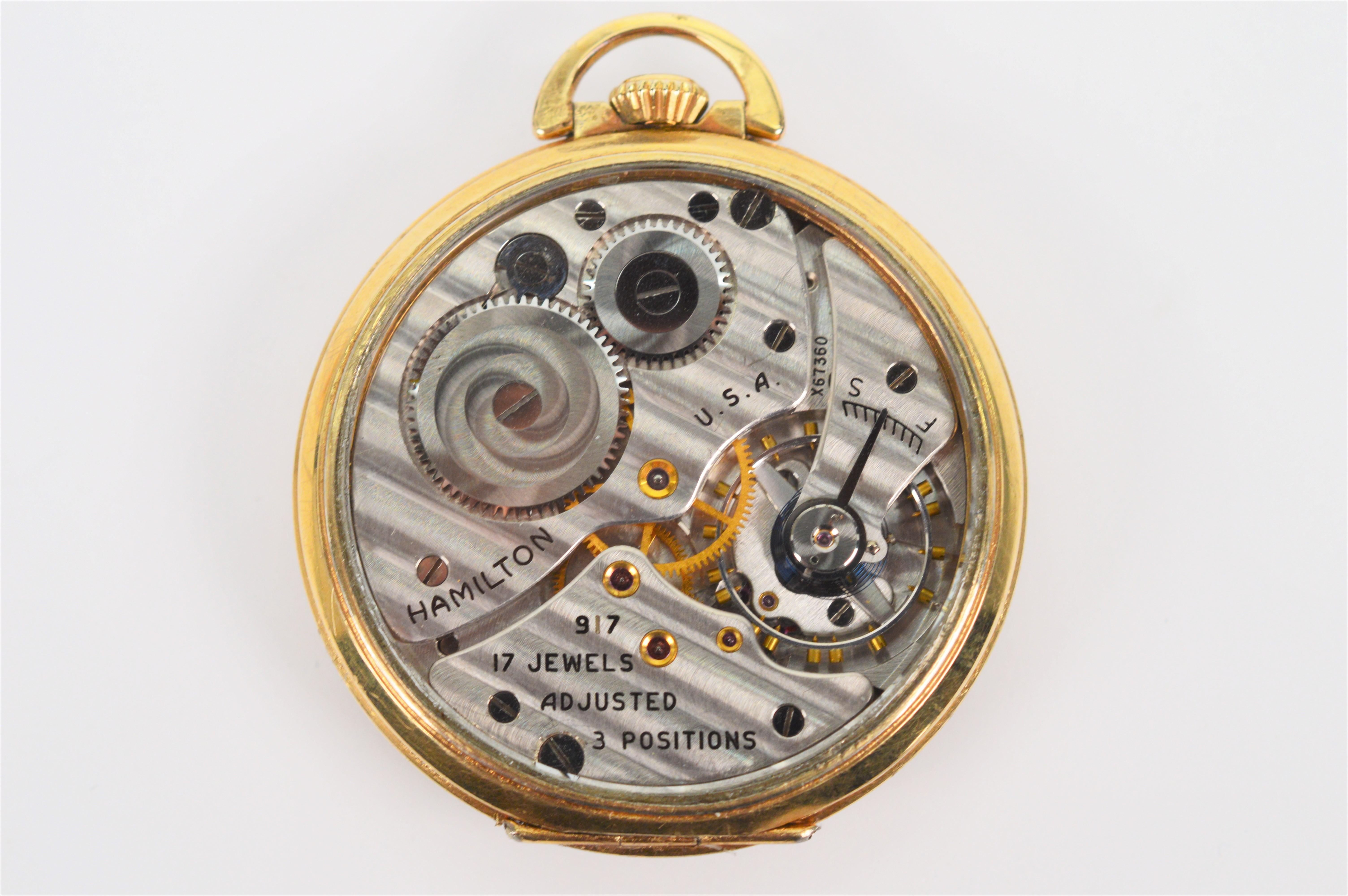Observe the mechanics of this circa 1939 ten karat yellow gold filled Hamilton Model 917 Men's Pocket Watch with skeleton display back. In watch size 10S, measuring approximately 1-3/4 inches, this vintage pocket timepiece has a silver toned face