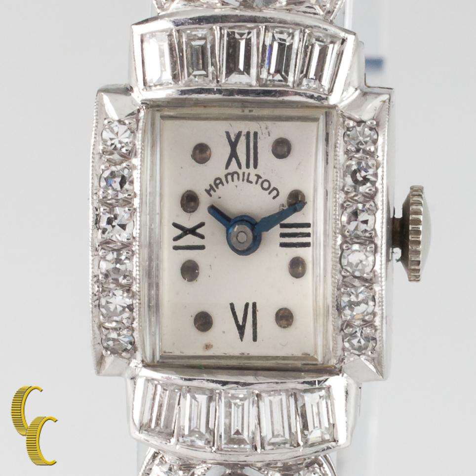 Total Diamond Weight = Approximately 2.66 ct
Average Color = G - H
Average Clarity = VS
Platinum Case w/ Diamond Bezel and Lugs
14 mm Wide (15 mm w/ Crown)
21 mm Long
Lug-to-Lug Length = 29 mm
Lug-to-Lug Width = 3 mm
Beige Dial w/ Black Numbers,