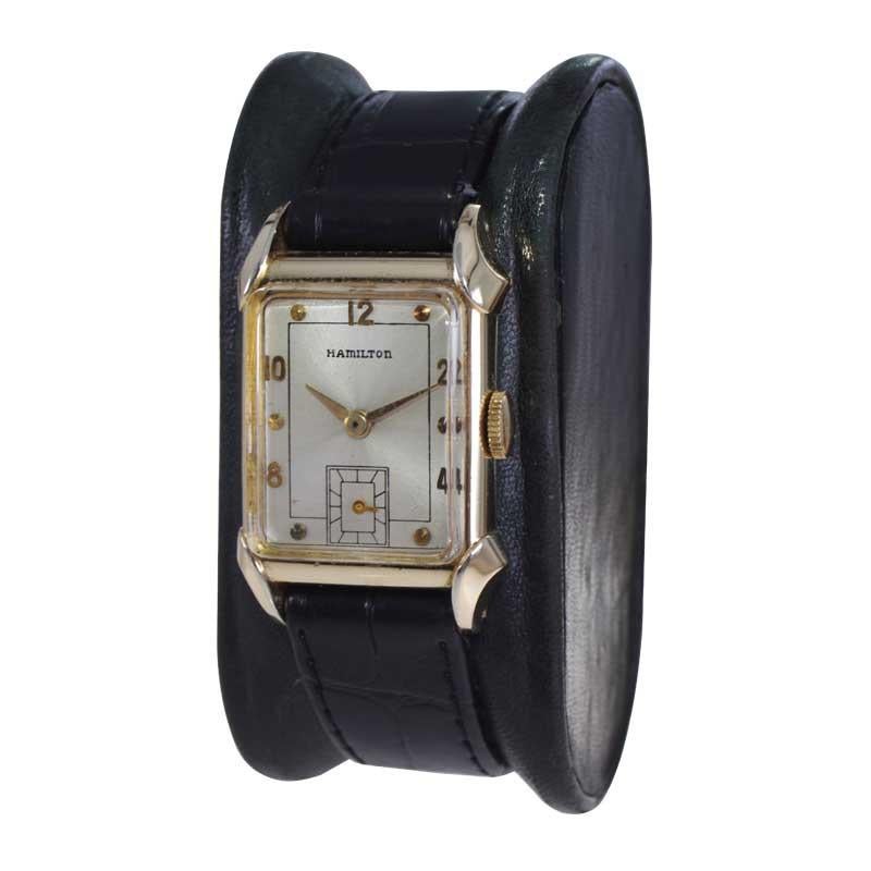 FACTORY / HOUSE: Hamilton Watch Company
STYLE / REFERENCE: Art Deco / Tank Style 
METAL / MATERIAL: Yellow Gold Filled 
CIRCA / YEAR: 1940
DIMENSIONS / SIZE: 36mm x 22mm 
MOVEMENT / CALIBER: Manual Winding / 19 Jewels / Caliber 982 
DIAL / HANDS: