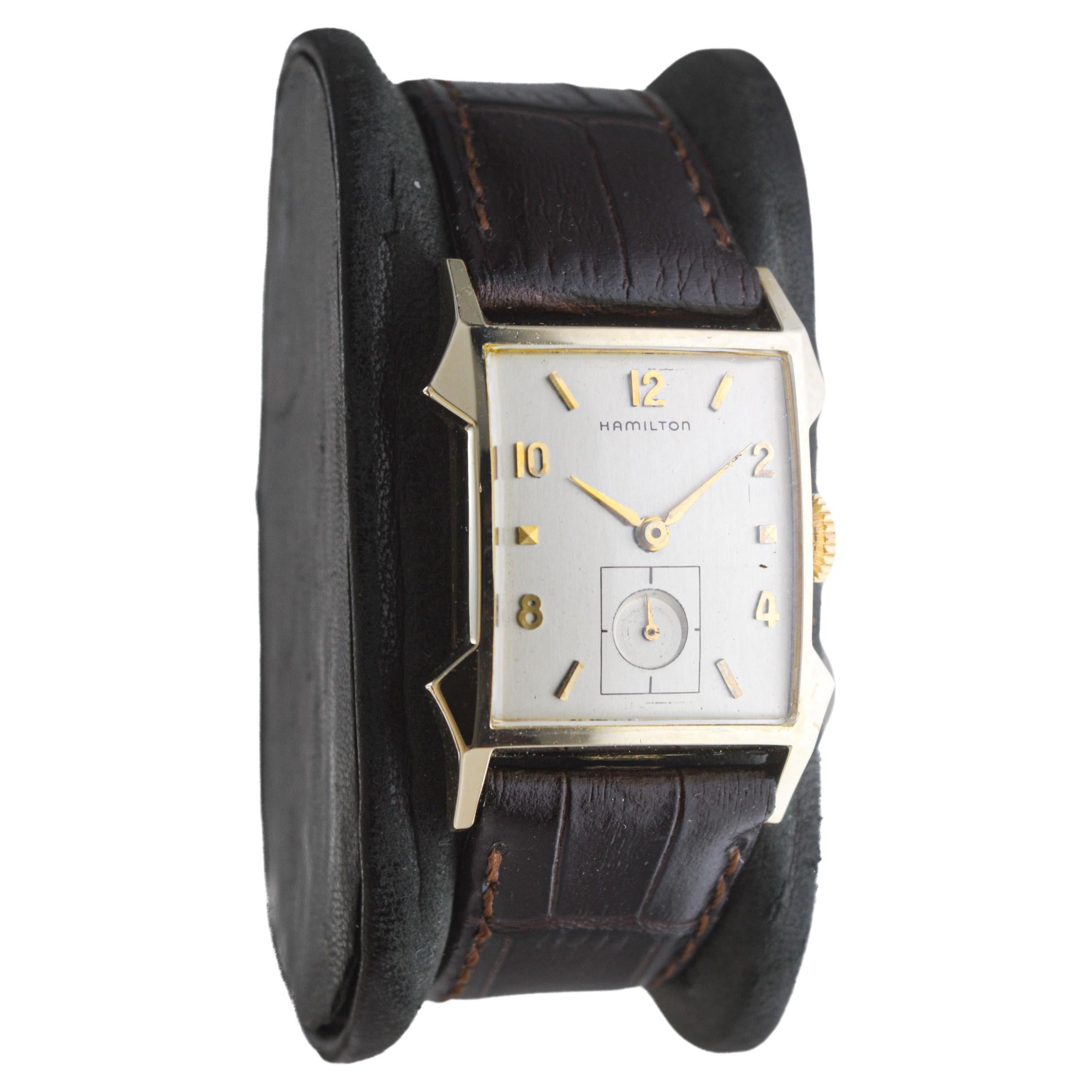 FACTORY / HOUSE: Hamilton Watch Company
STYLE / REFERENCE: Morton / Art Deco Tank Style 
METAL / MATERIAL: Yellow Gold Filled
CIRCA / YEAR: 1950's
DIMENSIONS / SIZE: Length 27mm X Width 36mm
MOVEMENT / CALIBER: Manual Winding / 22 Jewels / Caliber