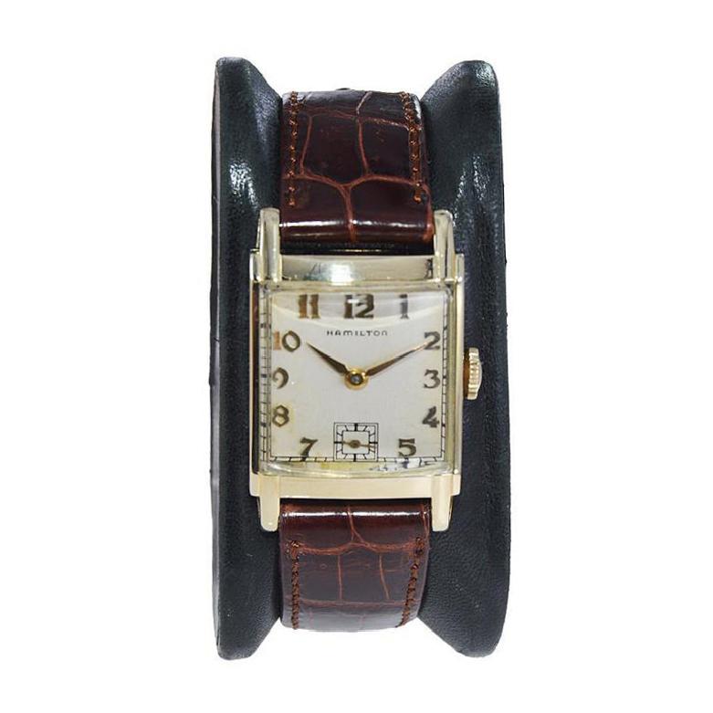 FACTORY / HOUSE: Hamilton Watch Company
STYLE / REFERENCE: Art Deco / Tank Style
METAL / MATERIAL: Yellow Gold Filled 
CIRCA / YEAR: Early 1940's
DIMENSIONS / SIZE: Length 35mm x Width 23mm
MOVEMENT / CALIBER: Manual Winding / 19 Jewels / Caliber