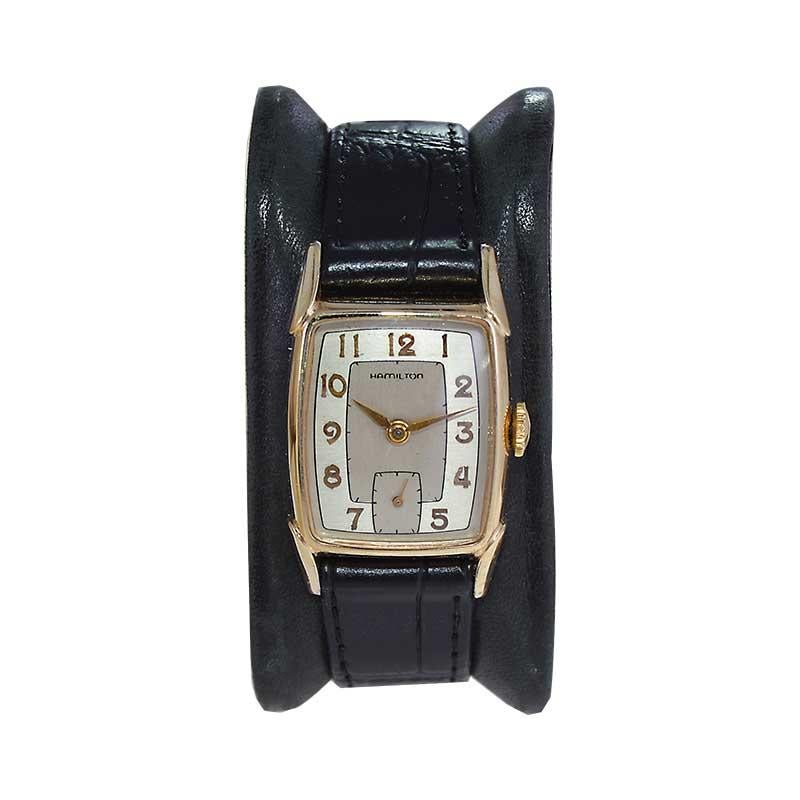 FACTORY / HOUSE: Hamilton Watch Company
STYLE / REFERENCE: Art Deco / Tonneau Shaped
METAL / MATERIAL: Yellow Gold Filled 
CIRCA / YEAR: 1940's
DIMENSIONS / SIZE: Length 36mm x Width 22mm 
MOVEMENT / CALIBER: Manual Winding / 17 Jewels / Caliber