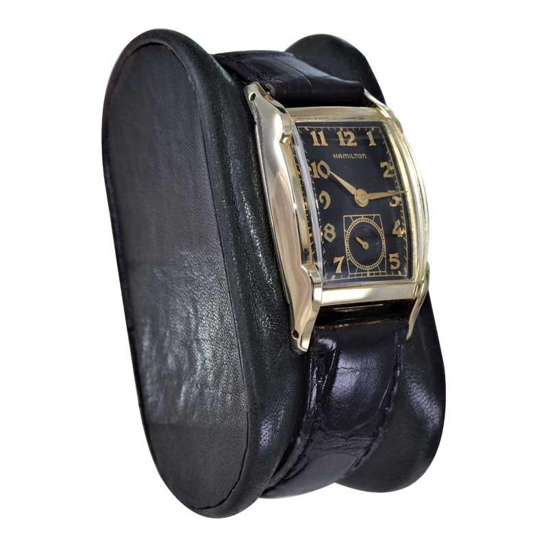 FACTORY / HOUSE: Hamilton Watch Company
STYLE / REFERENCE: Medford / Tonneau Shape
METAL / MATERIAL: Yellow Gold Filled 
CIRCA / YEAR: 1950
DIMENSIONS / SIZE: Length 38mm X Width 23mm
MOVEMENT / CALIBER: Manual Winding / 22 Jewels / Caliber 754
DIAL