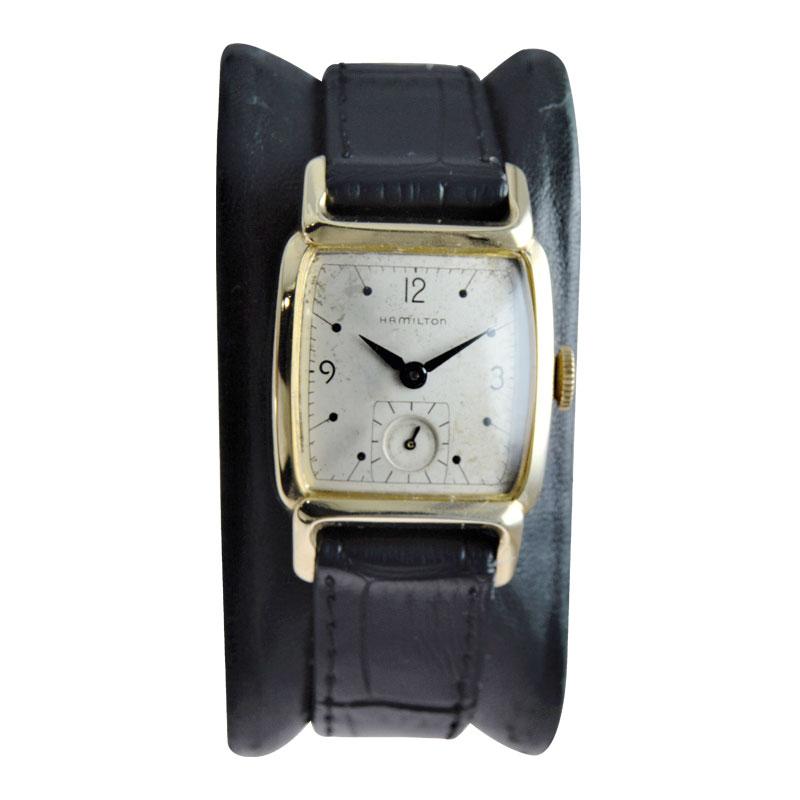 FACTORY / HOUSE: Hamilton Watch Co.
STYLE / REFERENCE: Art Deco
METAL / MATERIAL: Yellow Gold Filled
CIRCA / YEAR: 1940's
DIMENSIONS / SIZE: 38mm x 25mm
MOVEMENT / CALIBER: Manual Winding / 17 Jewels / Cal.747
DIAL / HANDS: Brushed Silver /