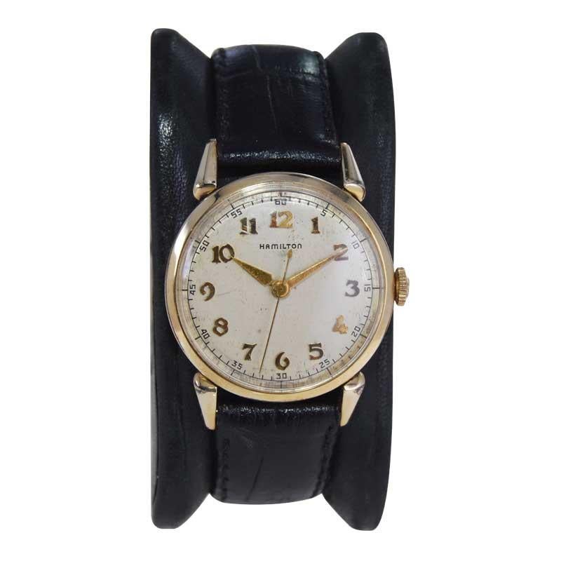 FACTORY / HOUSE: Hamilton Watch Company
STYLE / REFERENCE: Art Deco 
METAL / MATERIAL: 14kt GF
CIRCA / YEAR: 1950's
DIMENSIONS / SIZE: Length 37mm x Diameter 27mm
MOVEMENT / CALIBER: Manual Winding / 18 Jewels / Cal.748
DIAL / HANDS: Original